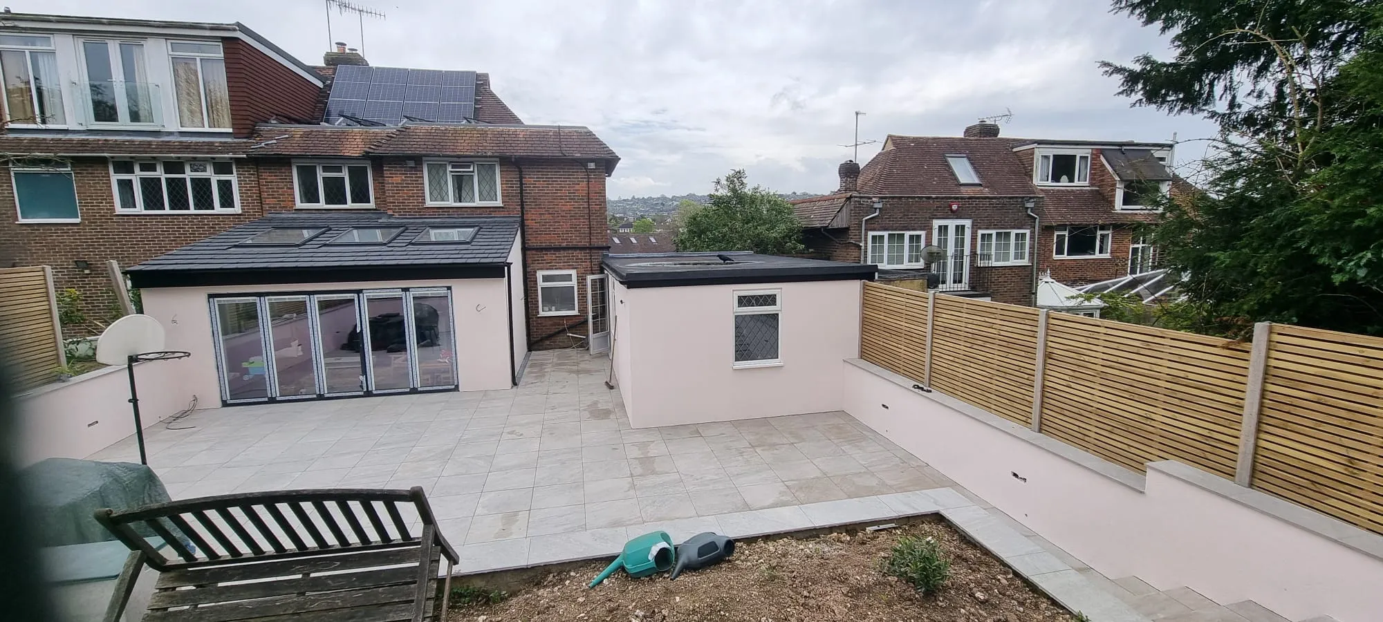 High-quality external rendering on a home extension and garden wall in Sussex