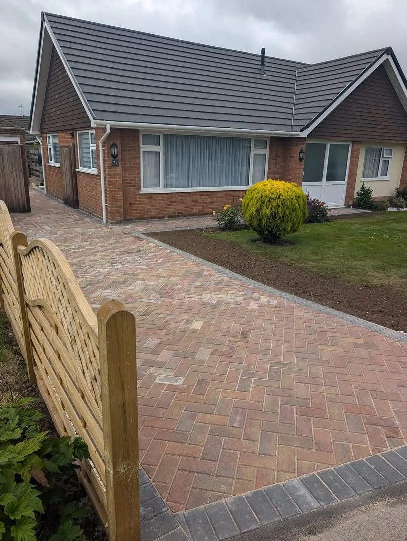 Professional block paving driveway and path installation in front of a residential home.