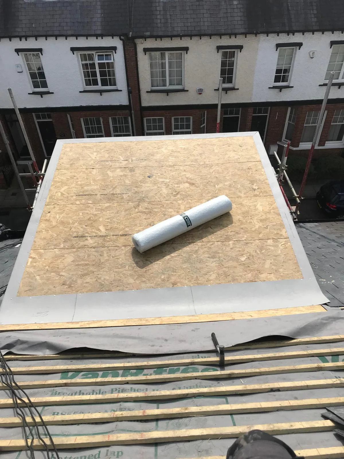 Roofing in progress, showing new flat roof decking and pitched roof battens on a property in York.