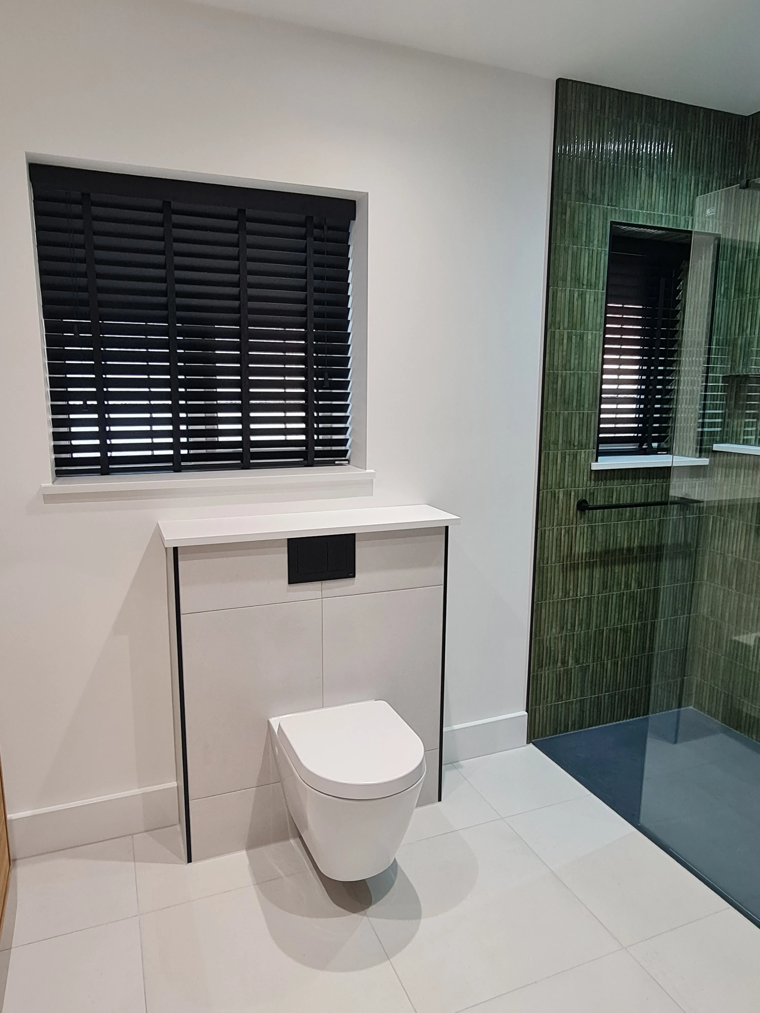Luxury bathroom installation in Plymouth featuring a bespoke walk-in shower and wall-hung toilet by Sands & Vossen.