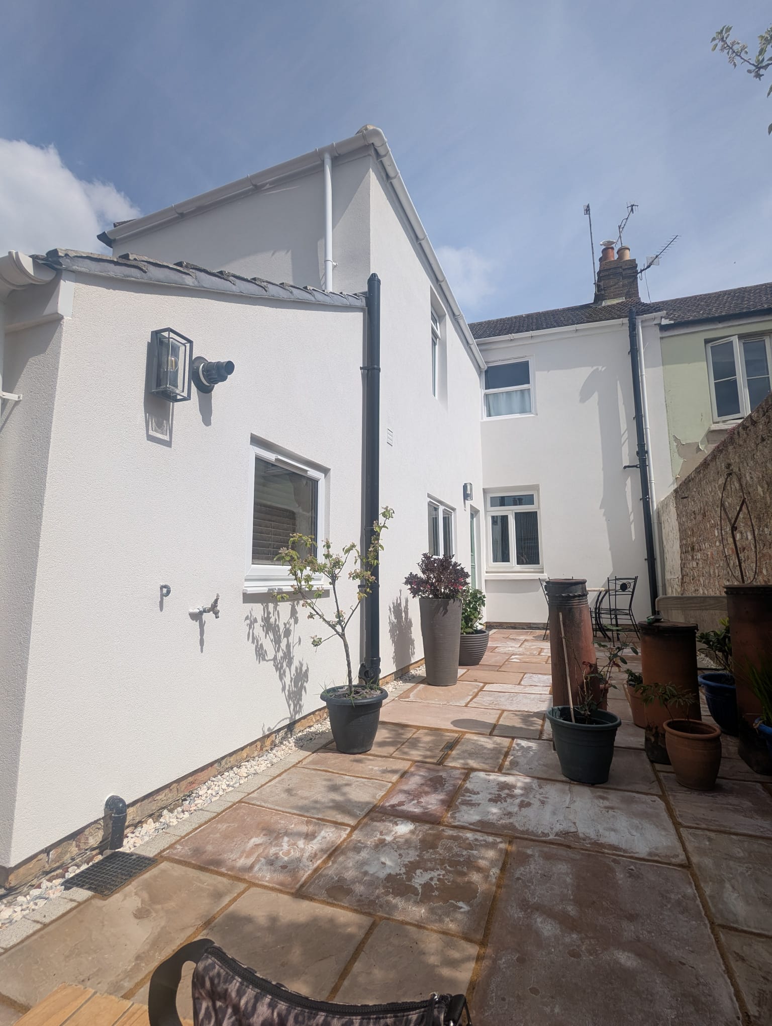 Professional white external wall rendering on a residential house in Sussex.