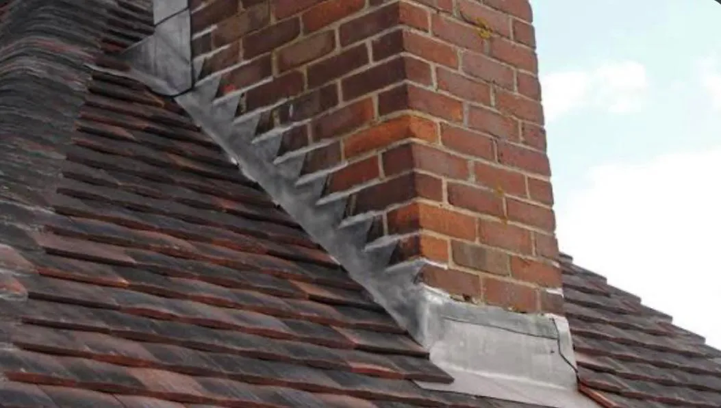 Expert lead flashing and chimney maintenance on a tiled roof in Devon.