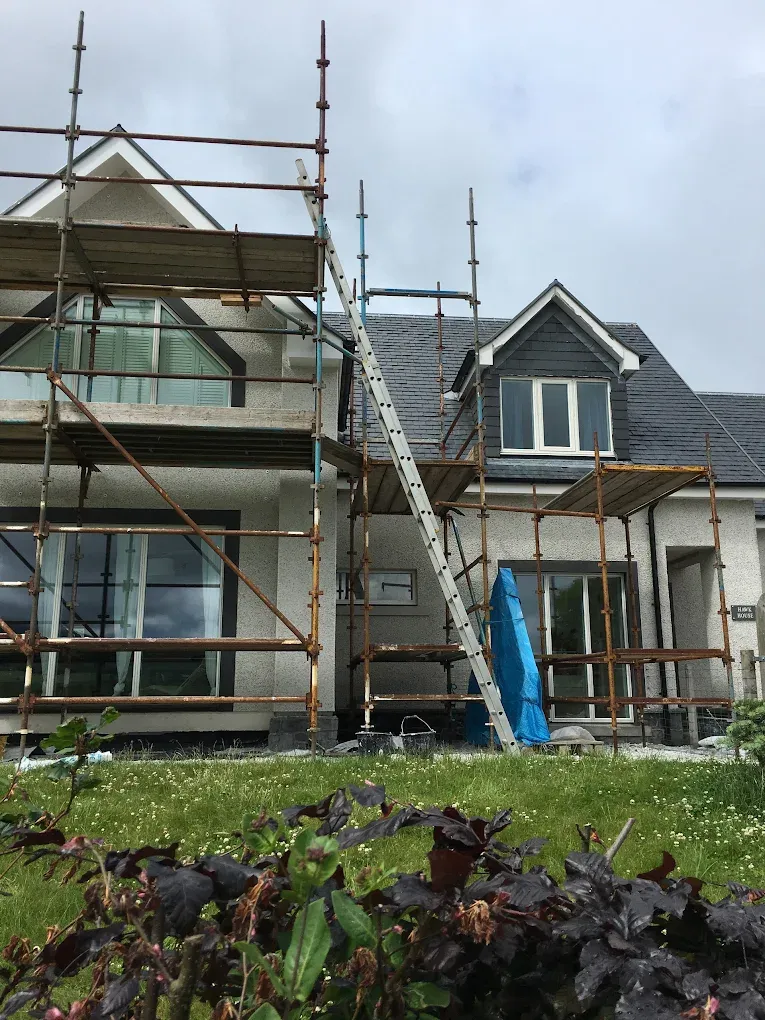 Scaffolding on a house for roughcasting and roofing work in Lanark