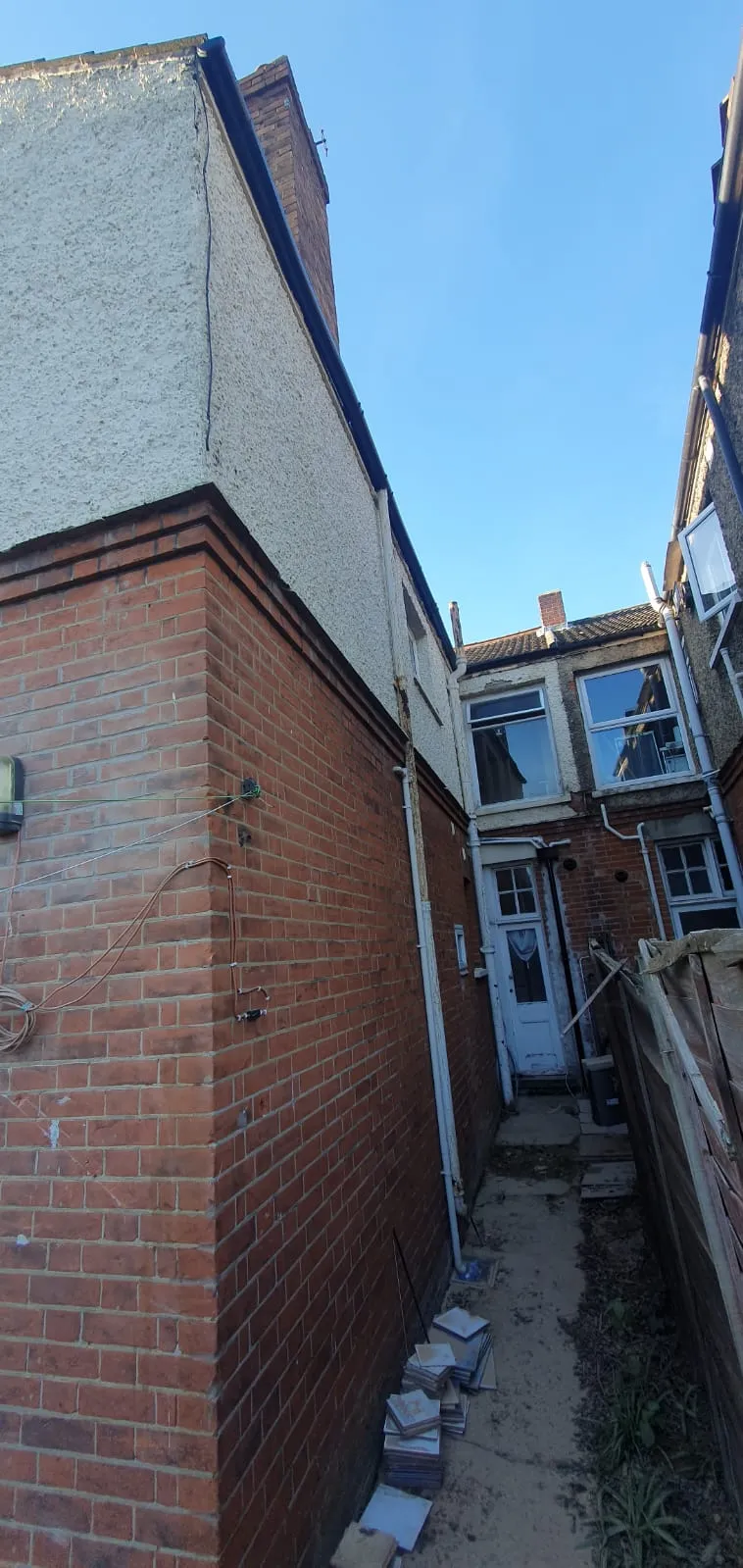 Exterior property maintenance and building services in Felixstowe showing house walls and wiring.