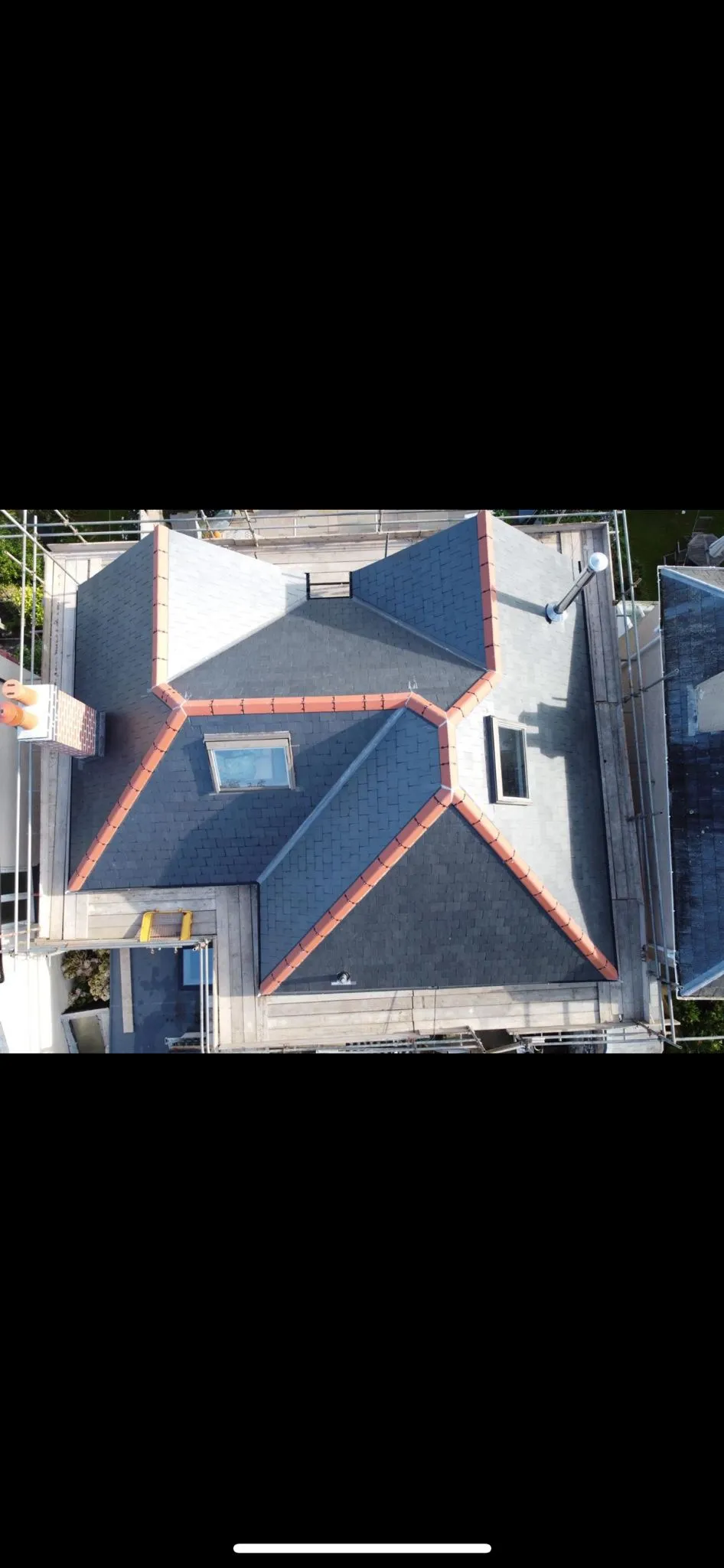 High-angle drone photograph of a professional slate and tile pitched roof installation by Sky Top Roofing LTD.