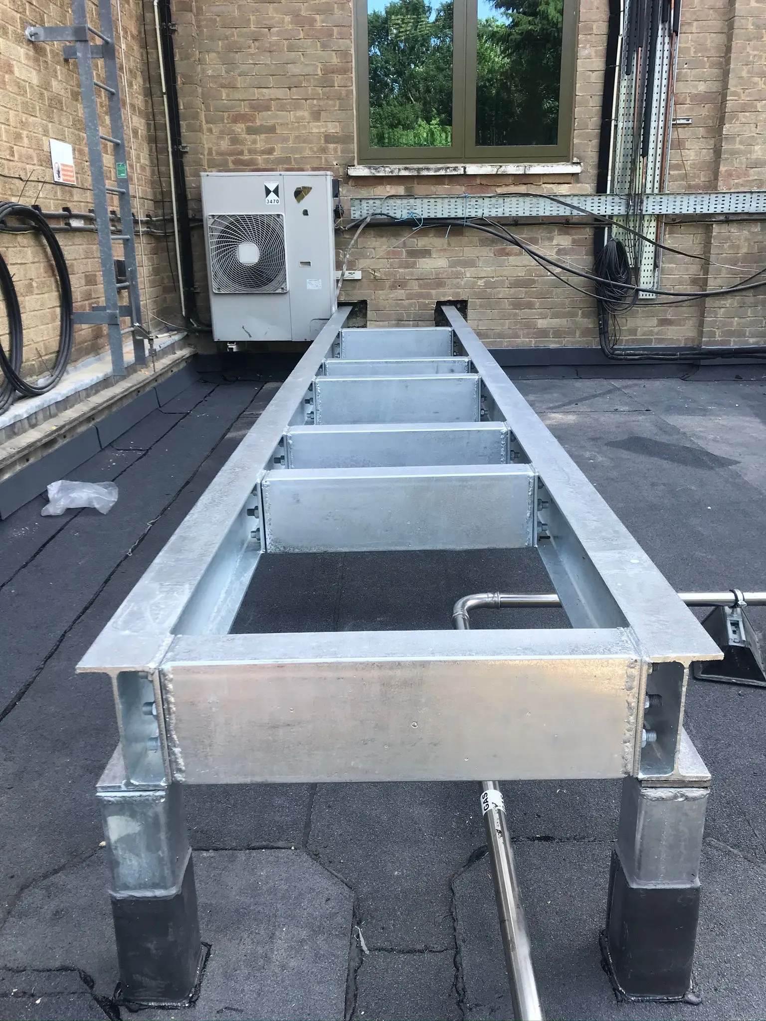 A picture of a galvanised steel frame installed on a flat roof