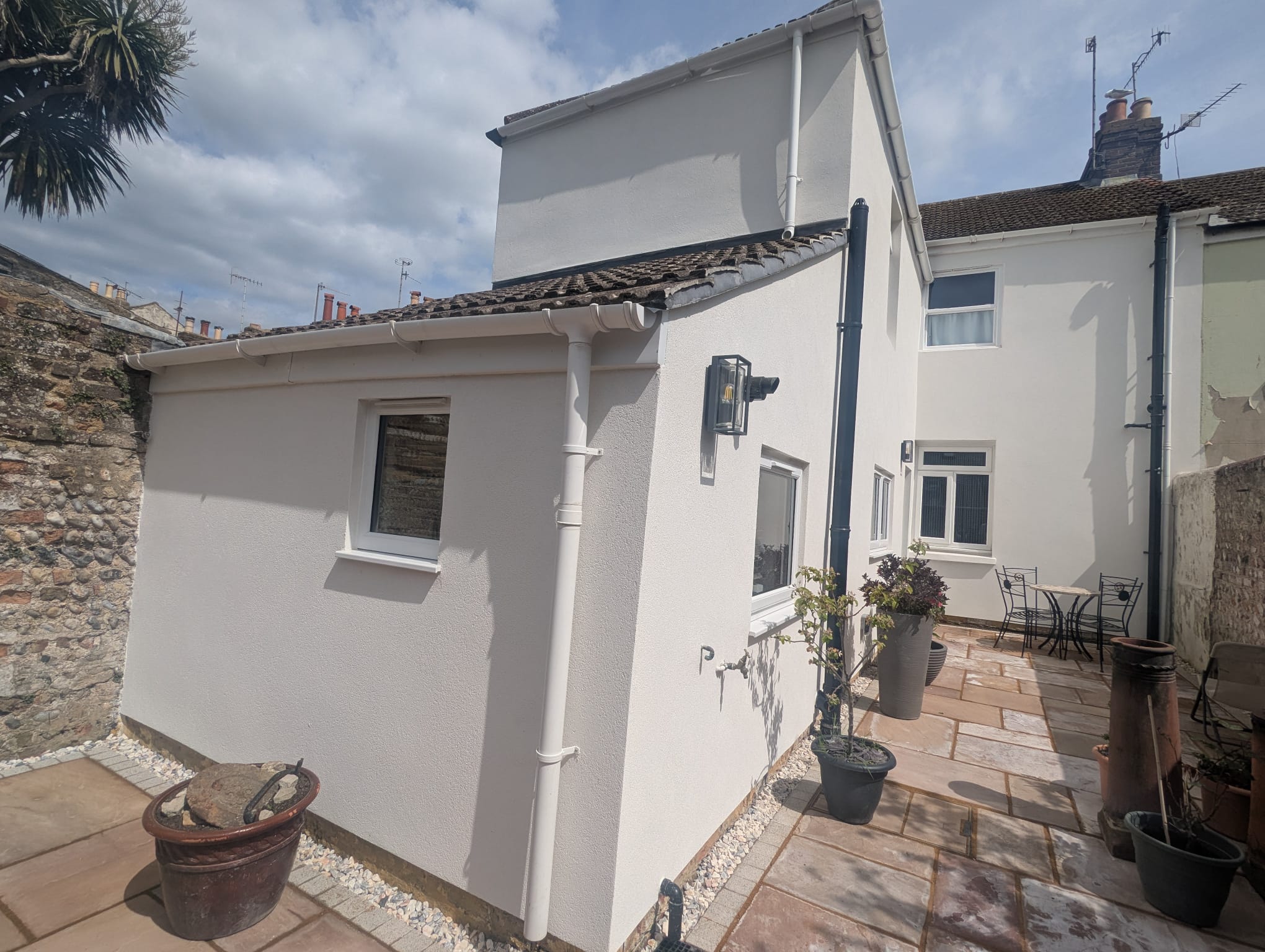 A residential property with a professional white external render finish on its rear extension.