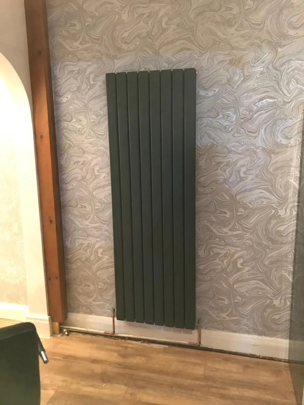 Vertical anthracite designer radiator installed by MK Plumbing LTD in a Greater Manchester home.