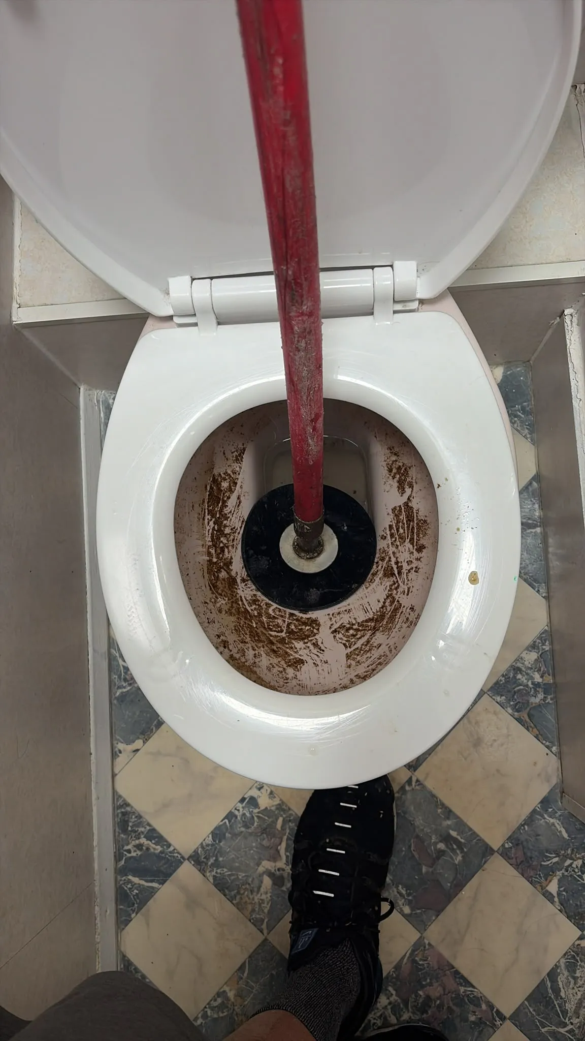 Emergency blocked toilet clearance using a manual plunger tool in Slough