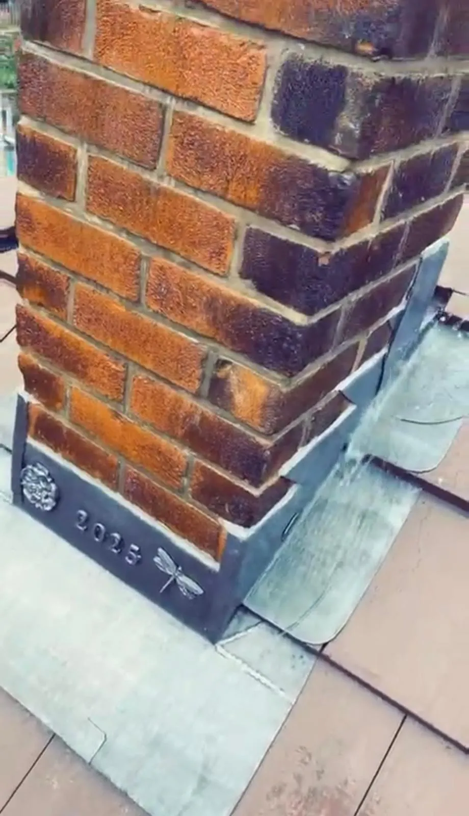 Bespoke lead flashing with decorative details on a brick chimney, completed by Tyler’s Roofing Services in Holmfirth.