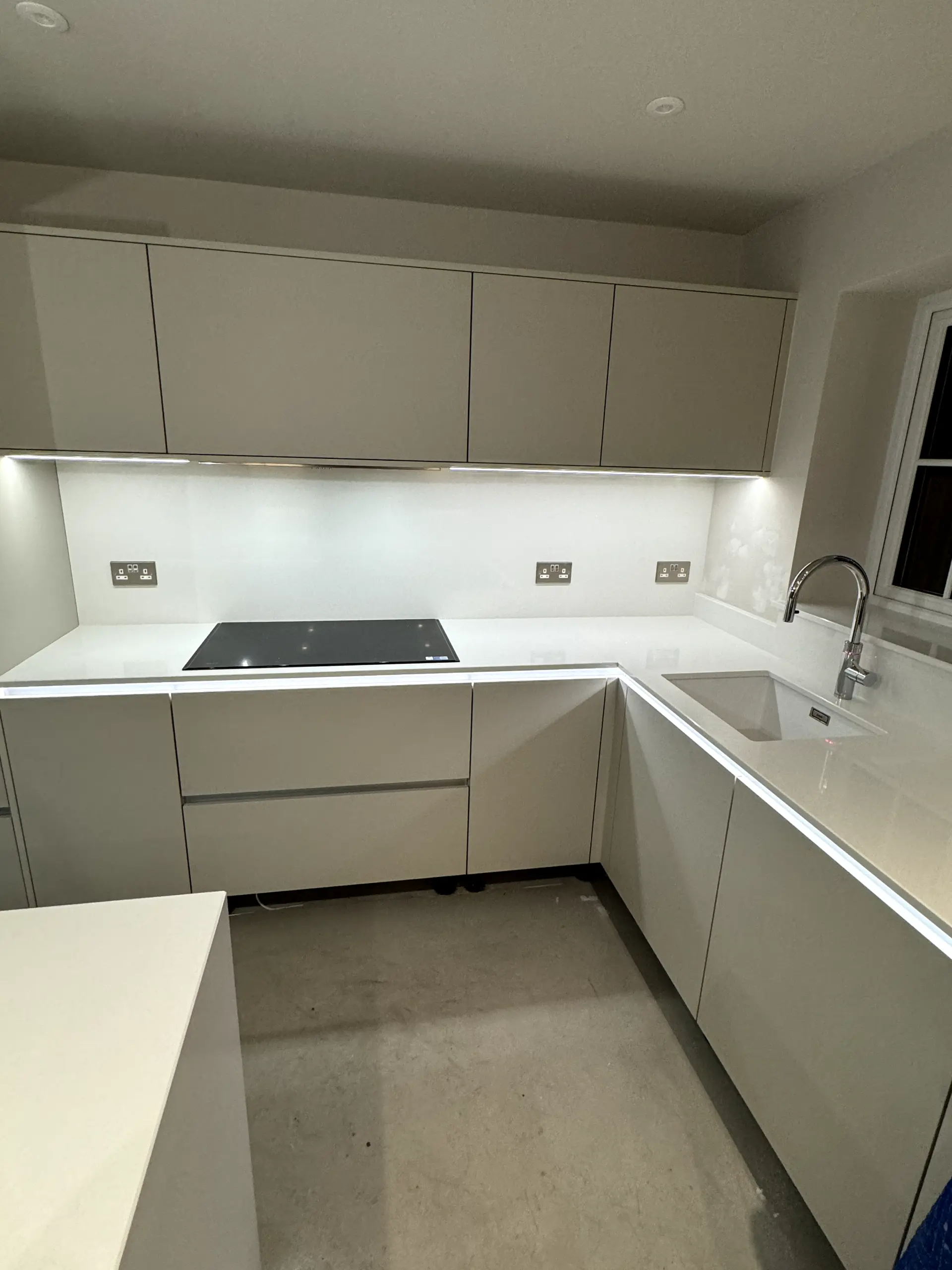 Modern kitchen electrical installation featuring custom LED profile lighting, under-cabinet lighting, and new double sockets by JH Electrical Contractors Ltd.