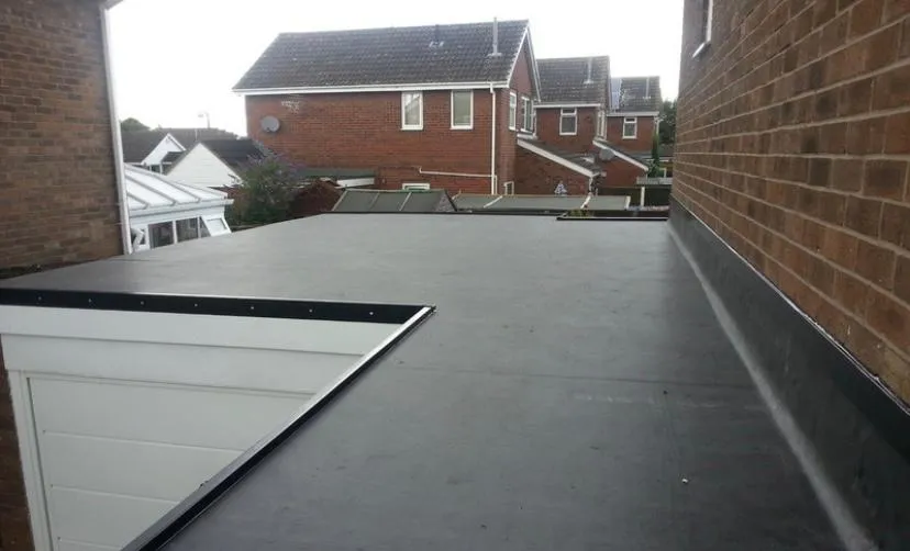 A newly installed flat roof on a residential extension or garage, showcasing modern flat roofing systems