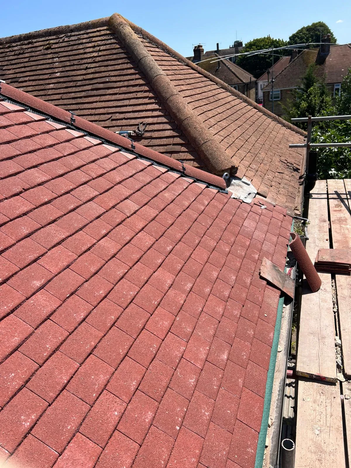 Professional new roof installation in West Malling featuring red roof tiles and scaffolding by First Choice Roofing Kent.