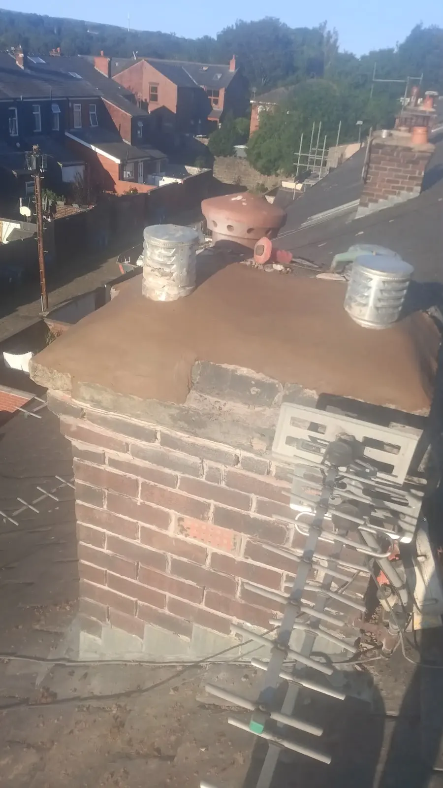 Fresh mortar flaunching on a repaired brick chimney stack in Burnley.