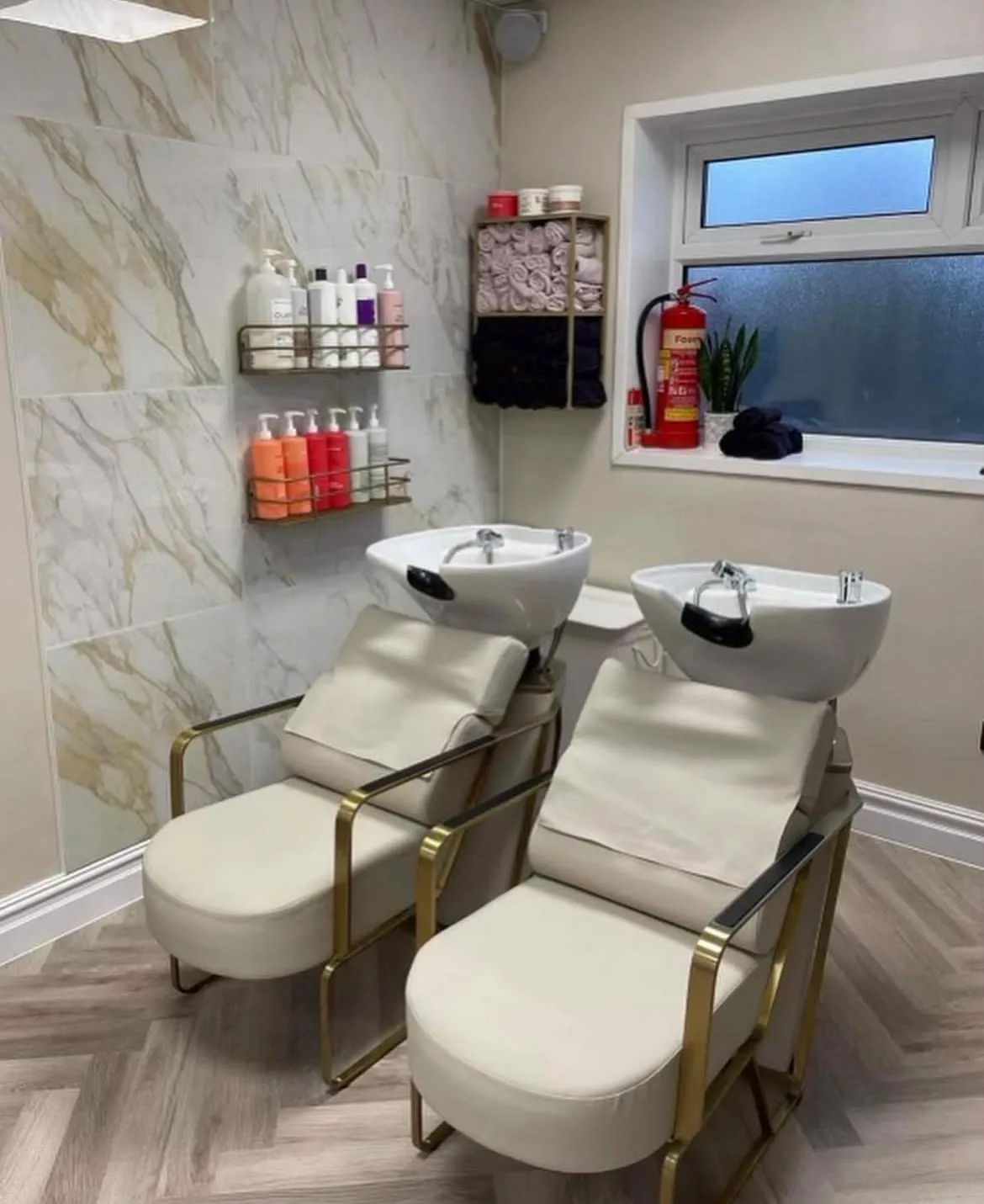 Modern hair salon wash station with professional plumbing and tiling by HM Bathroom and Heating.