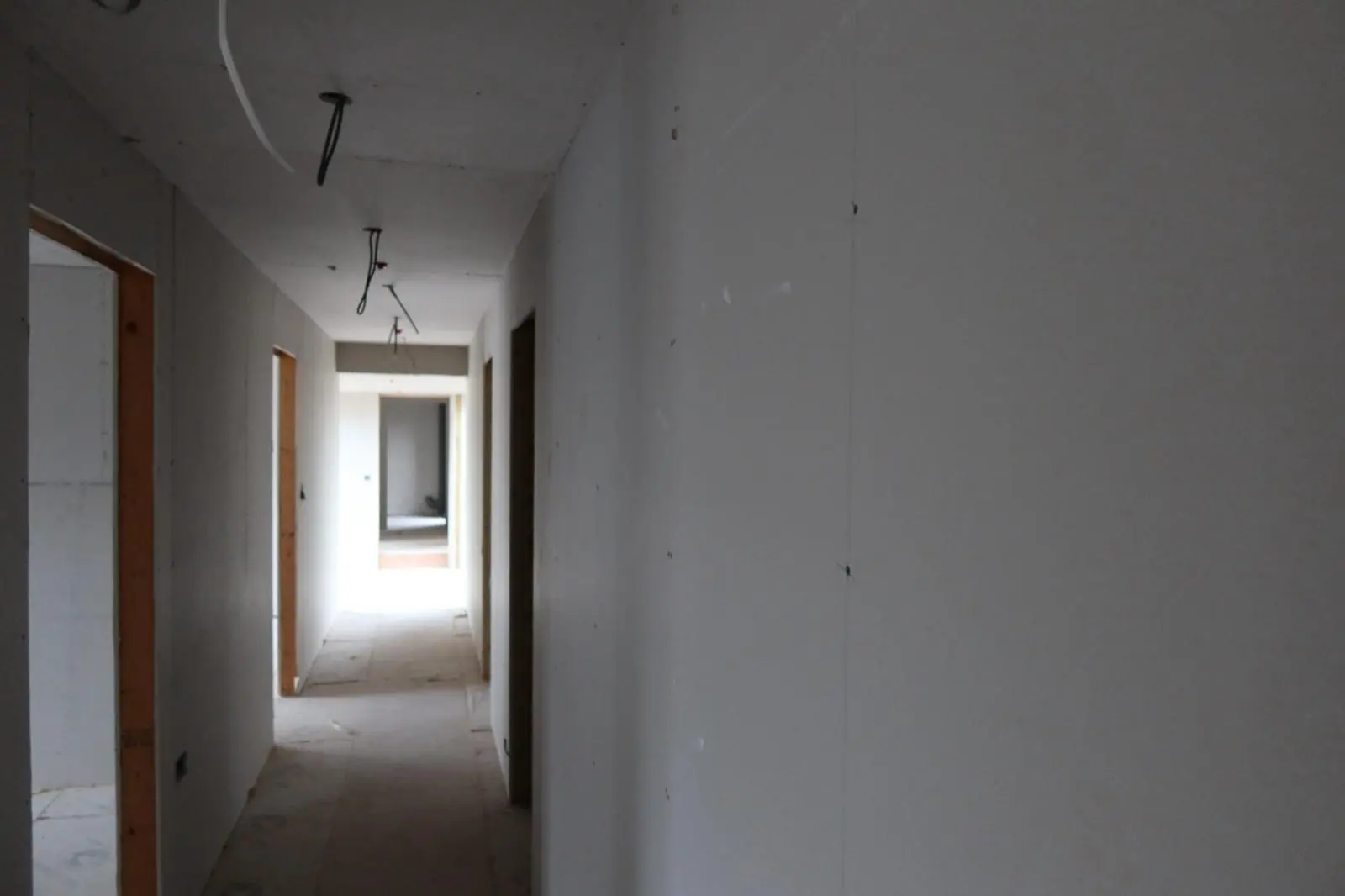 Newly installed plasterboard in a hallway ready for internal wall insulation and plastering finishes
