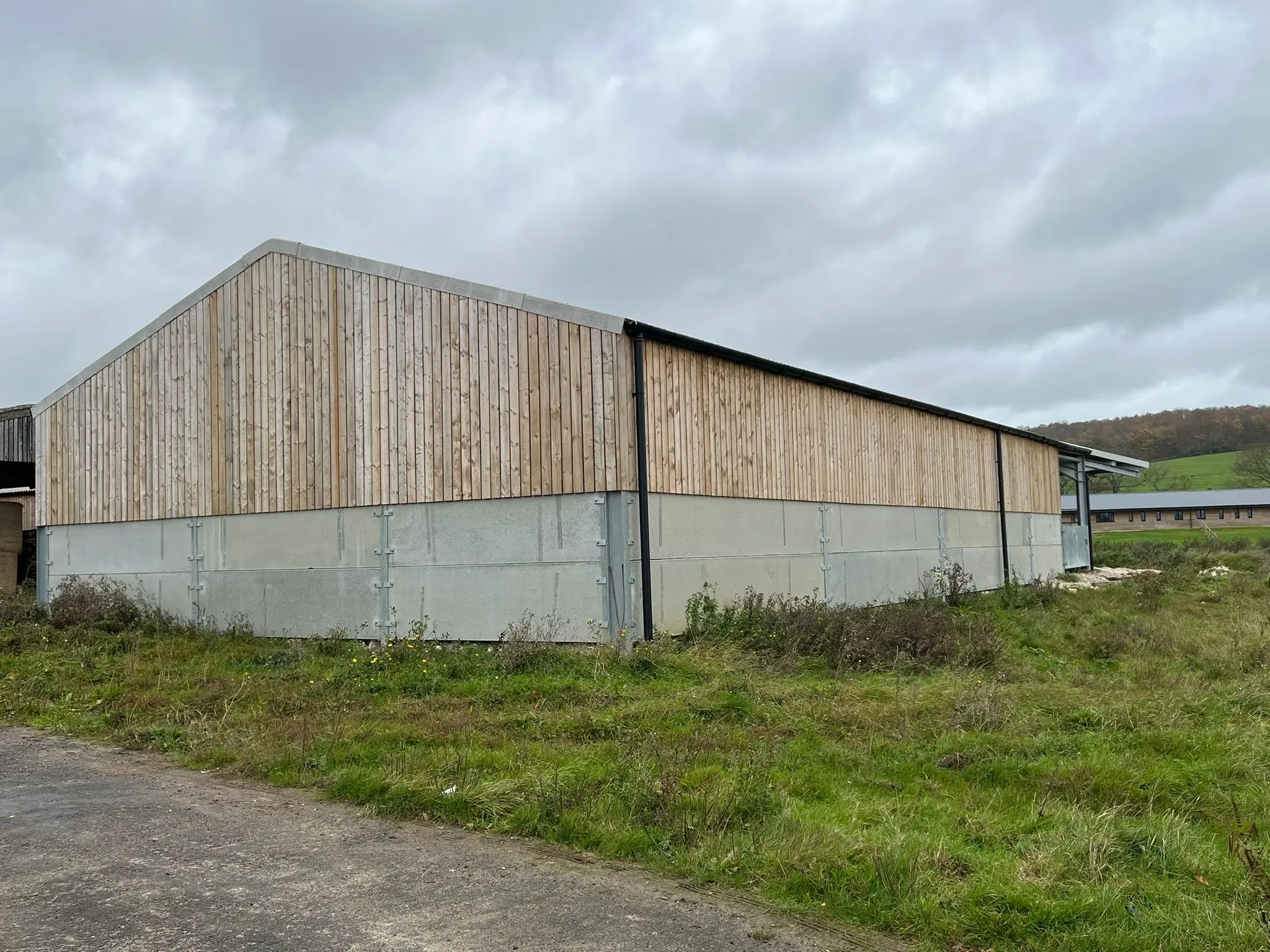 Newly built steel-framed agricultural barn with concrete panels and timber cladding by ER3 Group LTD