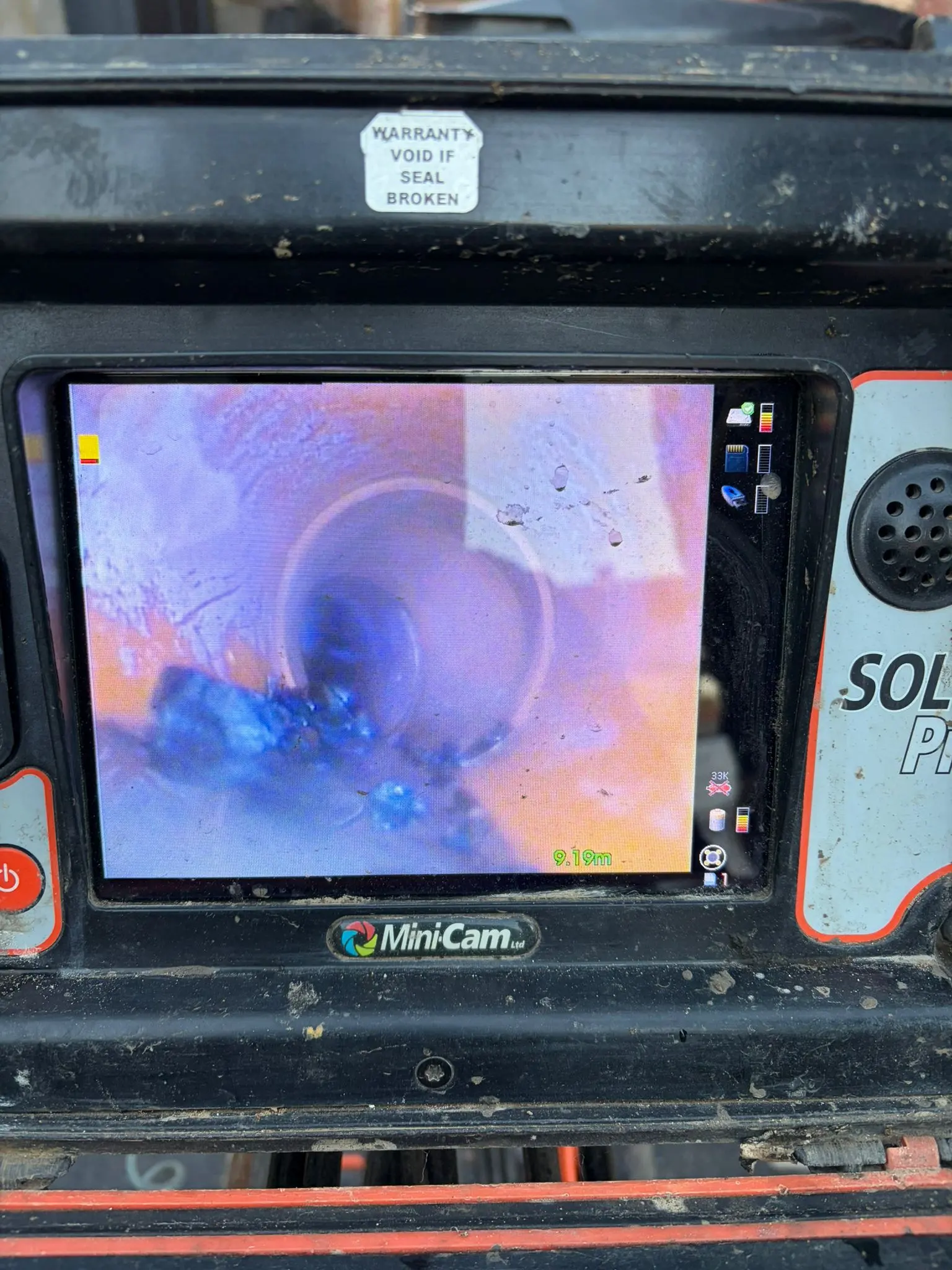 A professional CCTV drain inspection monitor showing the interior of a drainage pipe during a survey in Slough.
