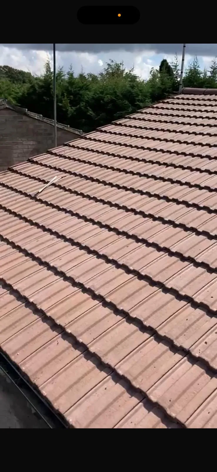 Professional tiled roof installation in Kent showing uniform rows of terracotta-coloured interlocking tiles on a pitched roof.