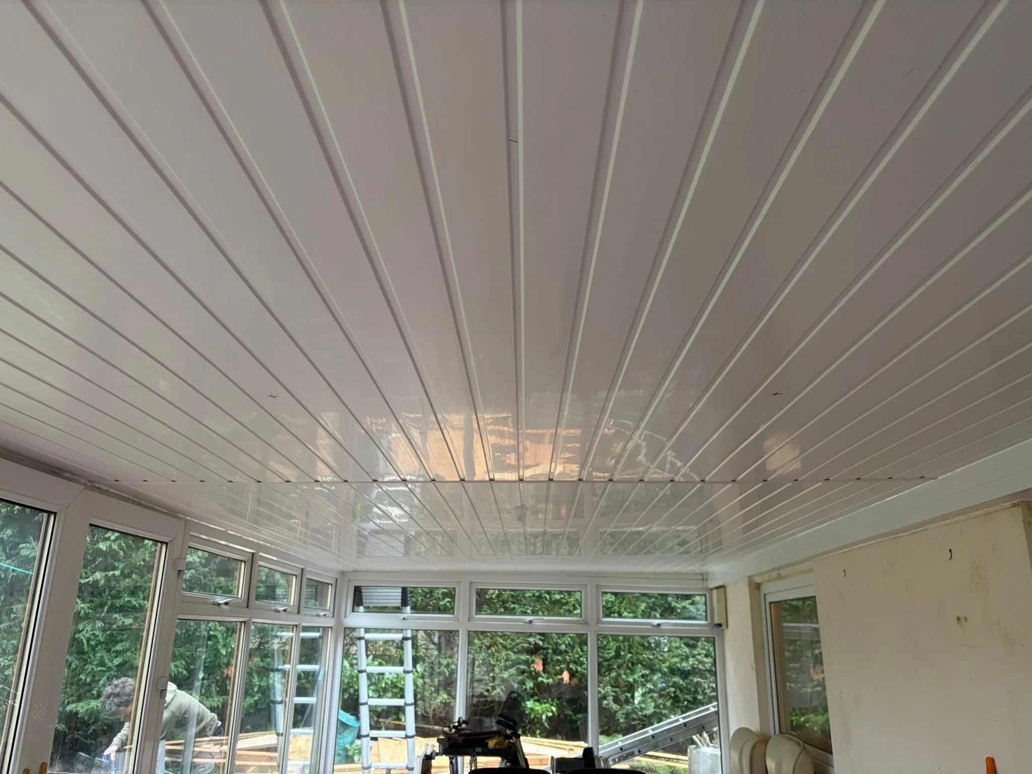 Internal uPVC ceiling installation for a conservatory warm roof in Blackburn by Lancashire Roofing Specialist.