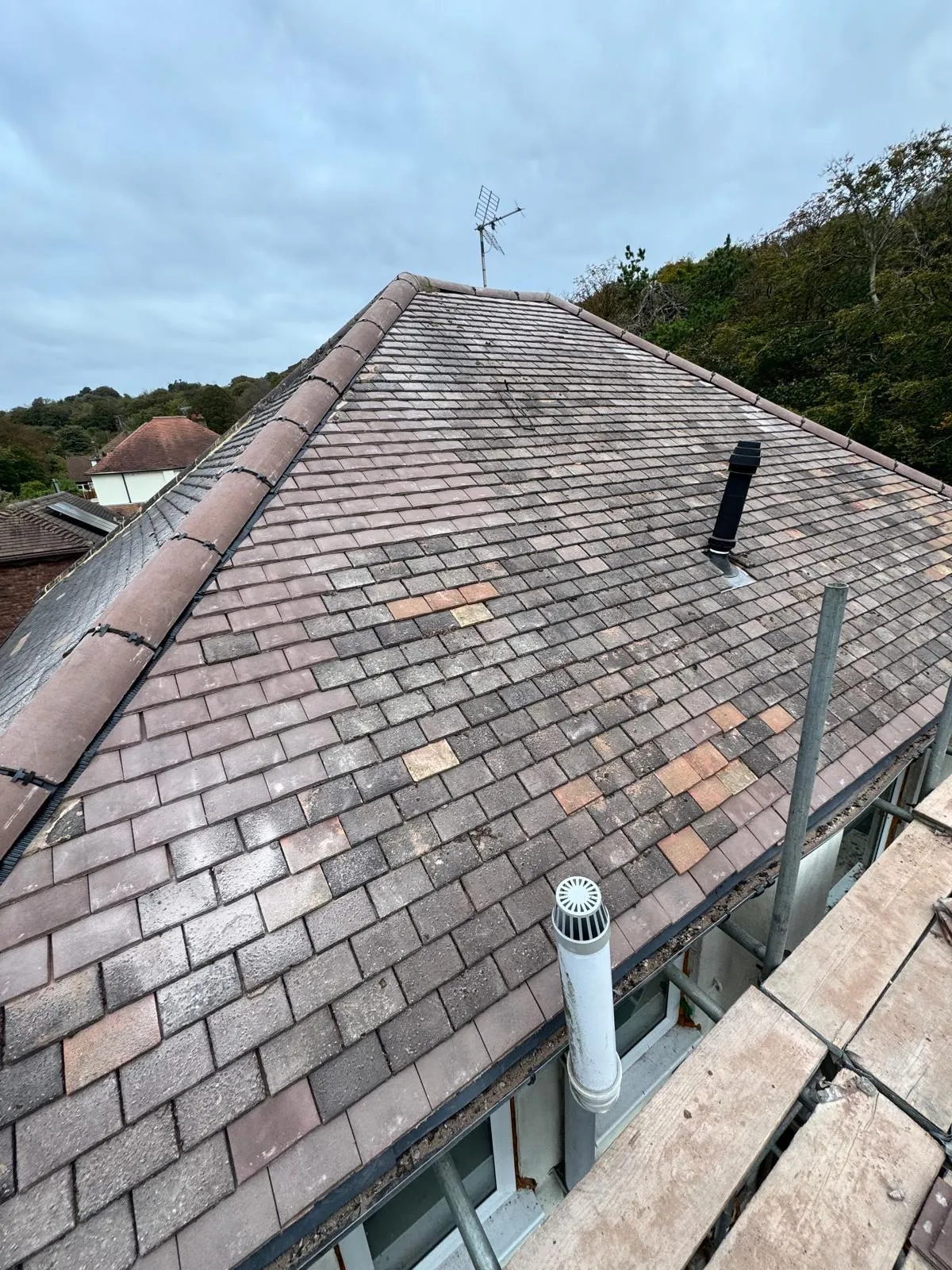 Professional roof tile replacement and pitched roof repairs in West Malling, showing new tiles and scaffolding by First Choice Roofing Kent.