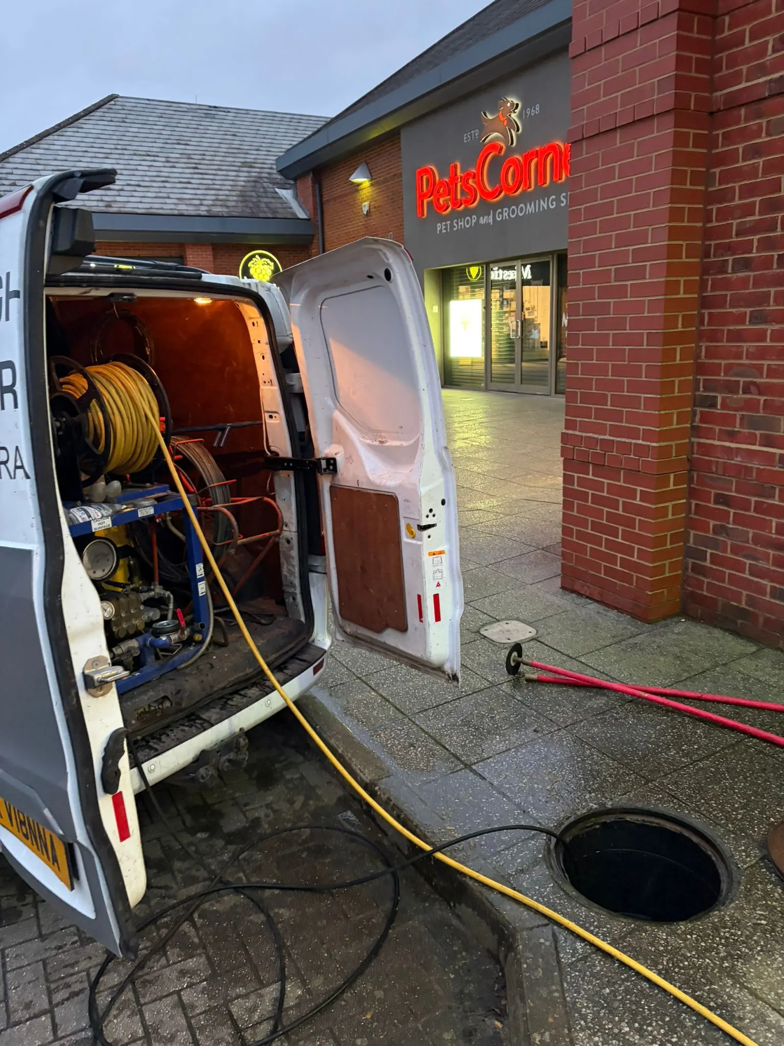Commercial high-pressure drain jetting service being carried out at a business location in Slough.