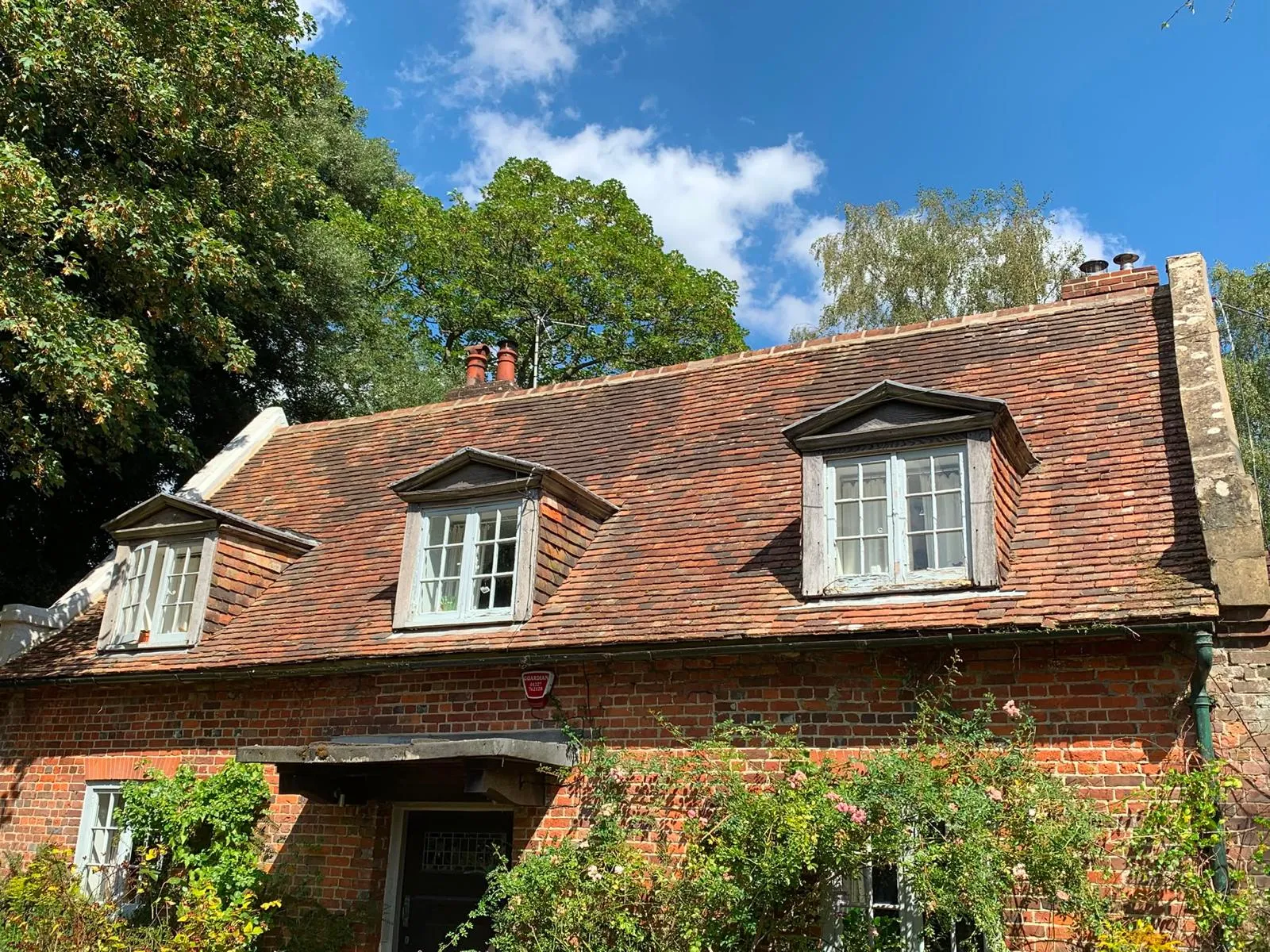 Traditional Kent peg tile roof on a period brick cottage with dormer windows