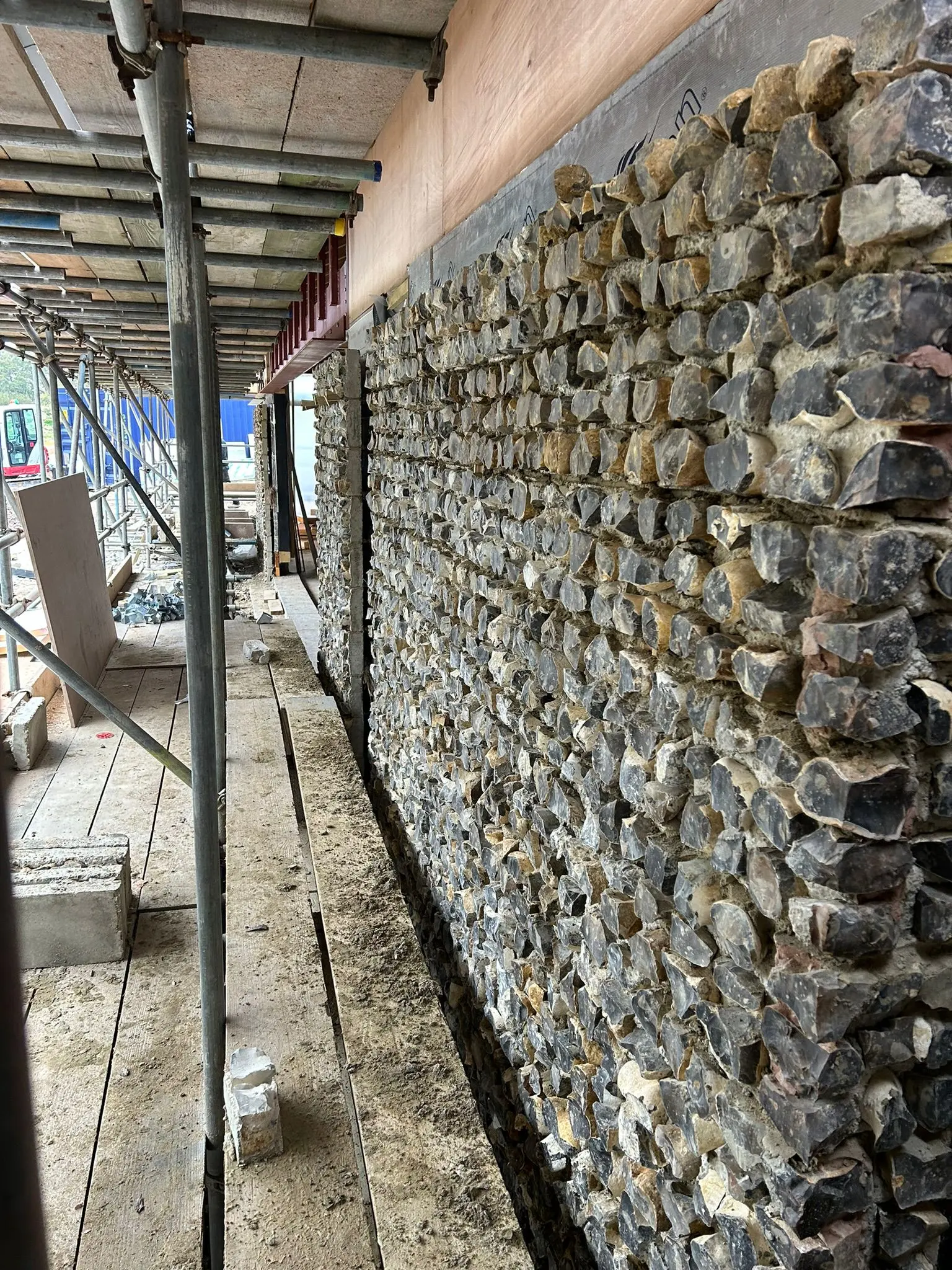 Traditional knapped flint stone masonry under construction