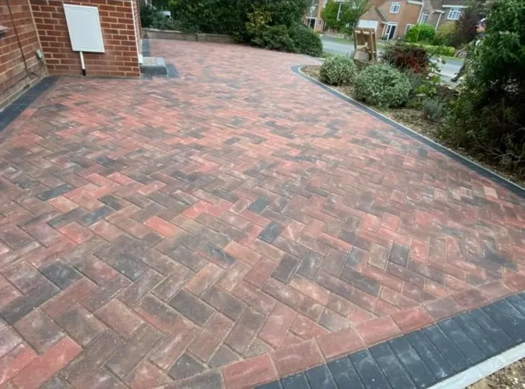 A professionally installed block paving driveway in a herringbone pattern.