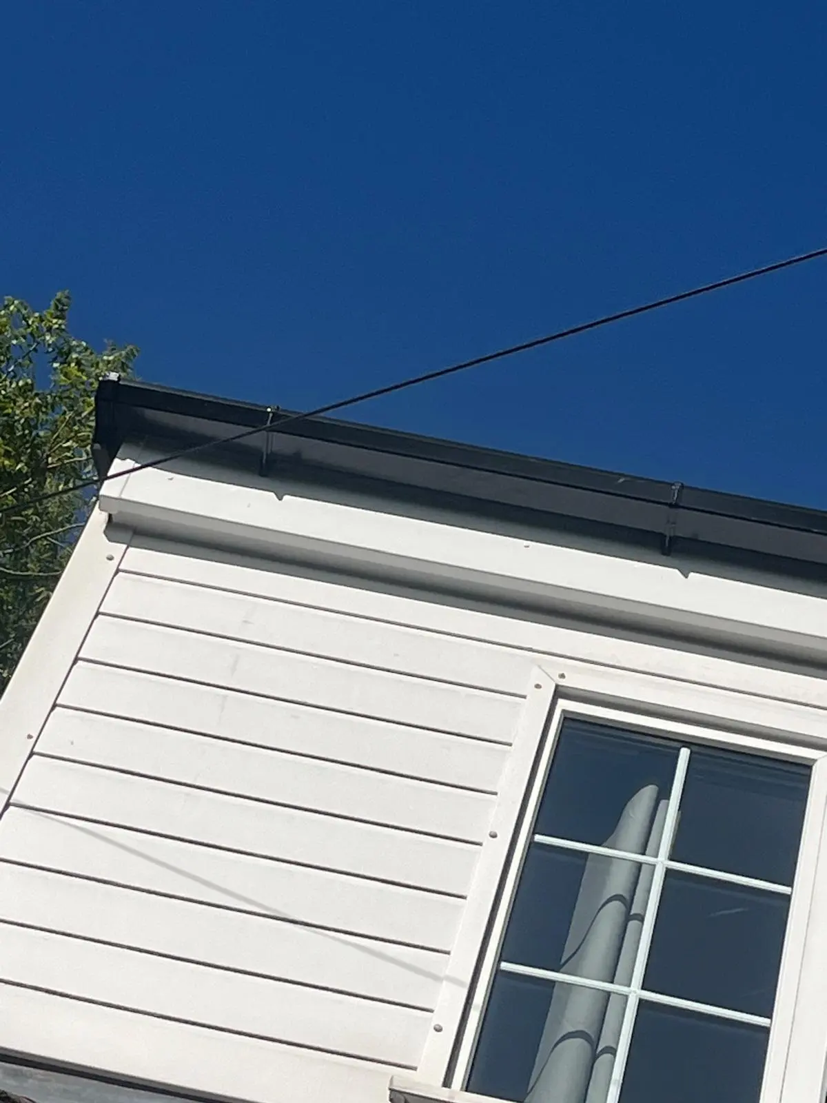 Newly installed white uPVC cladding, fascias, and black guttering on a home