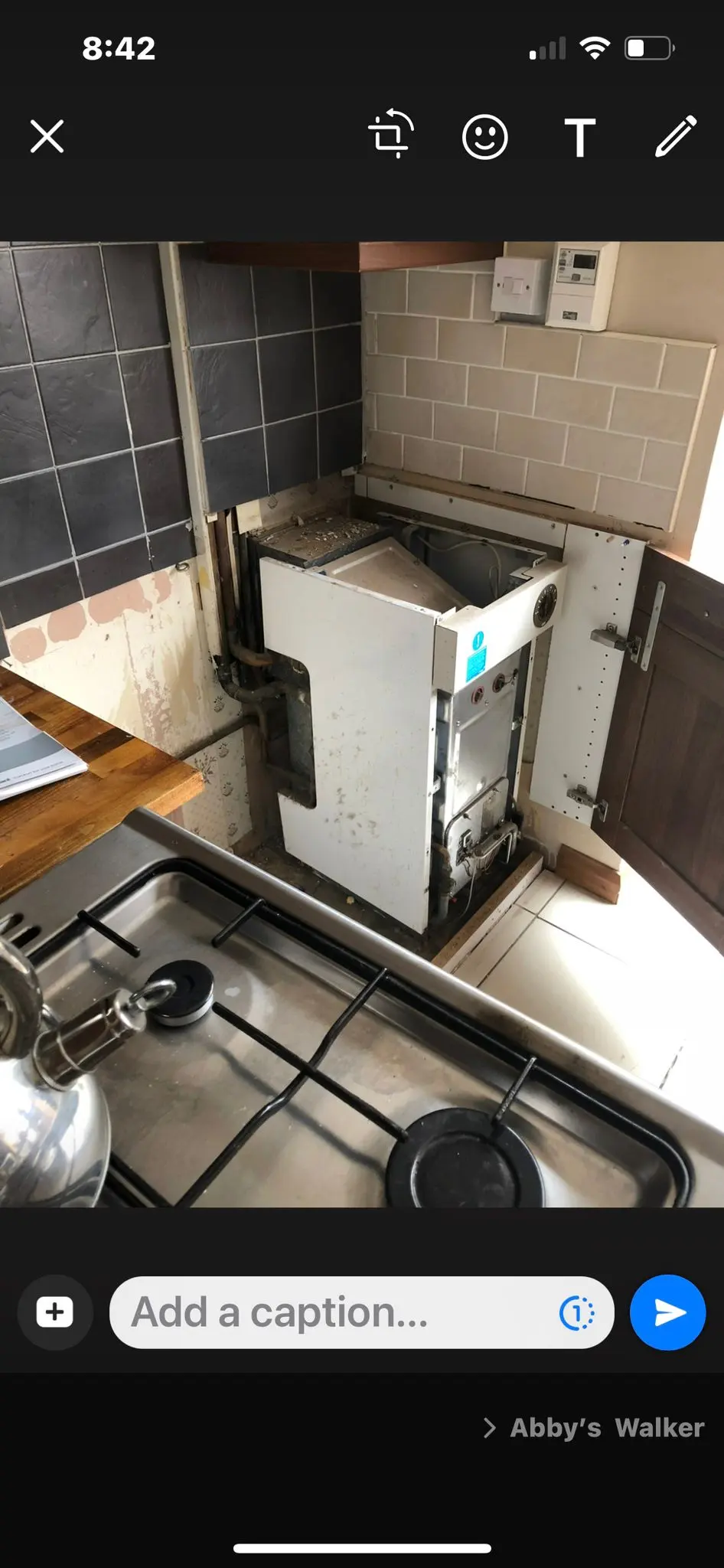 Gas Safe registered engineer performing a boiler installation or repair in a Wolverhampton kitchen.