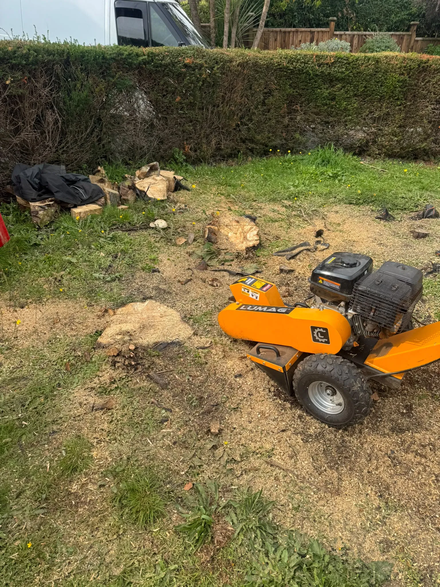 Lumag stump grinder in operation removing tree stumps from a lawn by JDP Outdoor Solutions