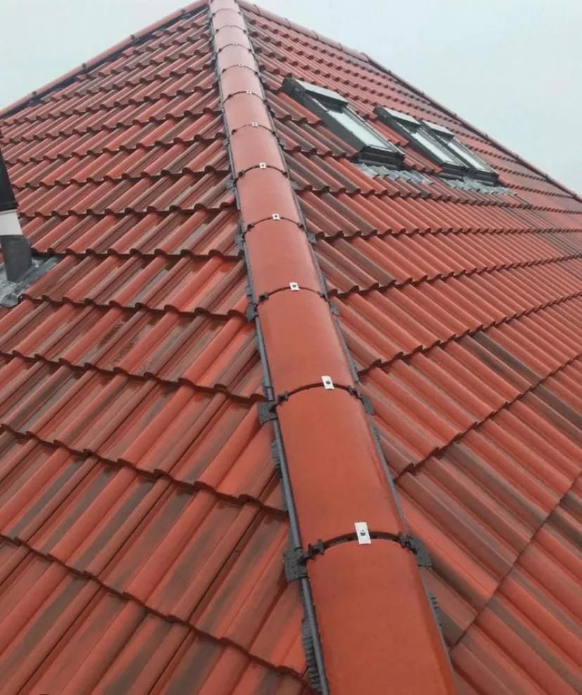 Newly fitted terracotta tiled roof with a dry ridge system and Velux windows