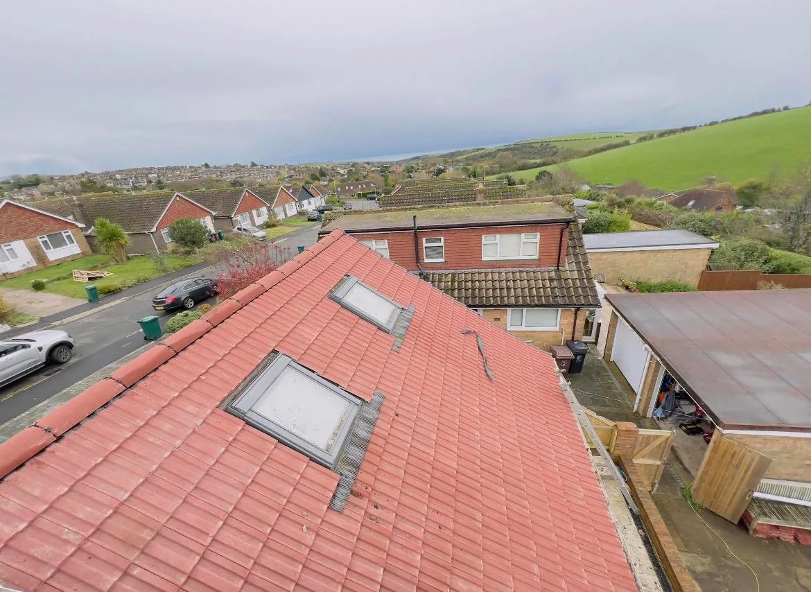 High-angle view of a new red-tiled roof with skylights