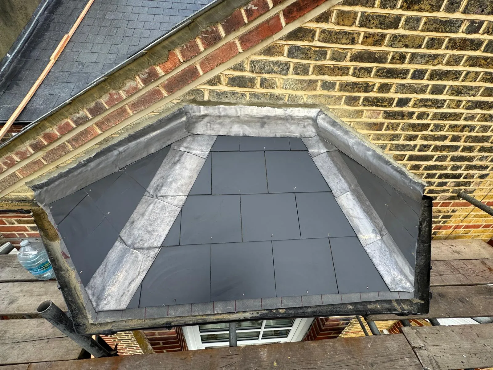 High-quality slate and leadwork installation on a bay window roof by professional roofers in Cornwall.