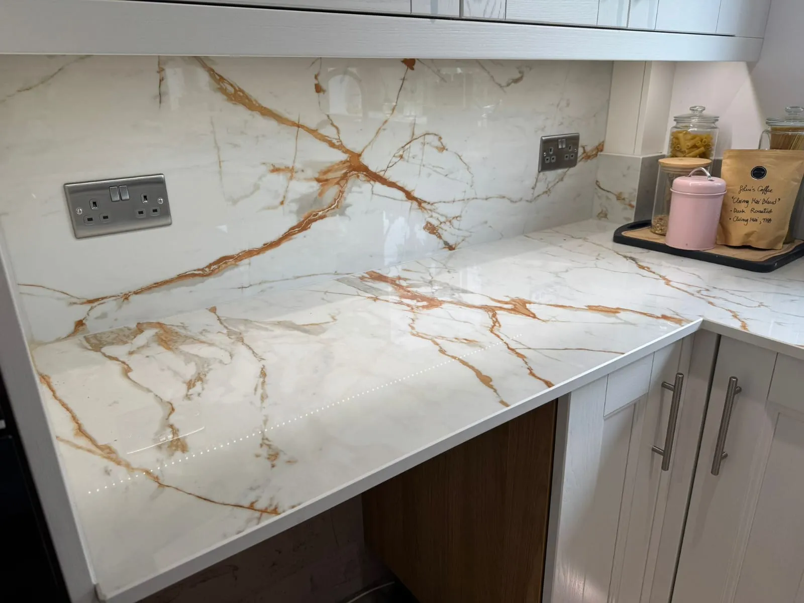 Modern marble-effect kitchen countertop and splashback installation by FLEX PROPERTY SERVICES in Felixstowe.