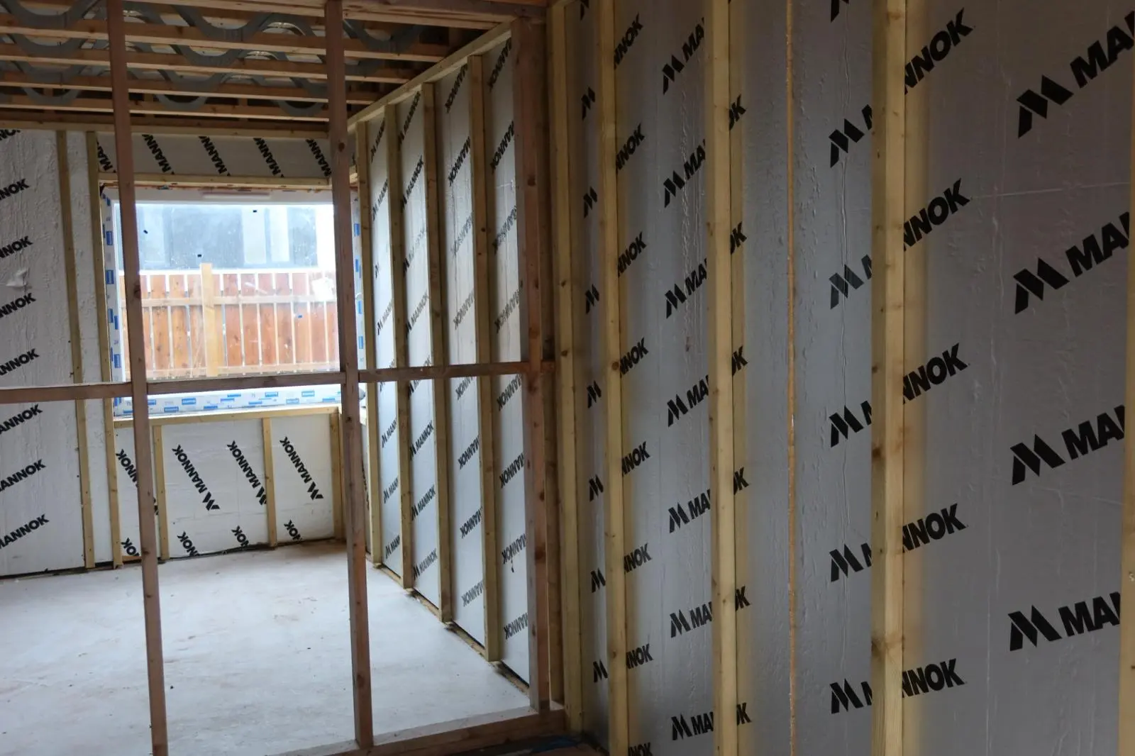 Internal wall insulation installation showing rigid PIR boards fitted between timber studs to improve home thermal efficiency