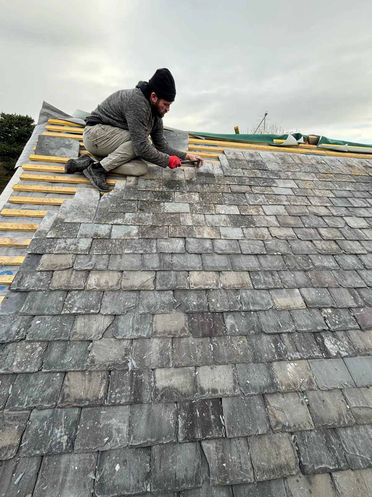 Expert roofer from Premium Roofing Contractors carrying out a high-quality slate roofing installation in Ellesmere Port.