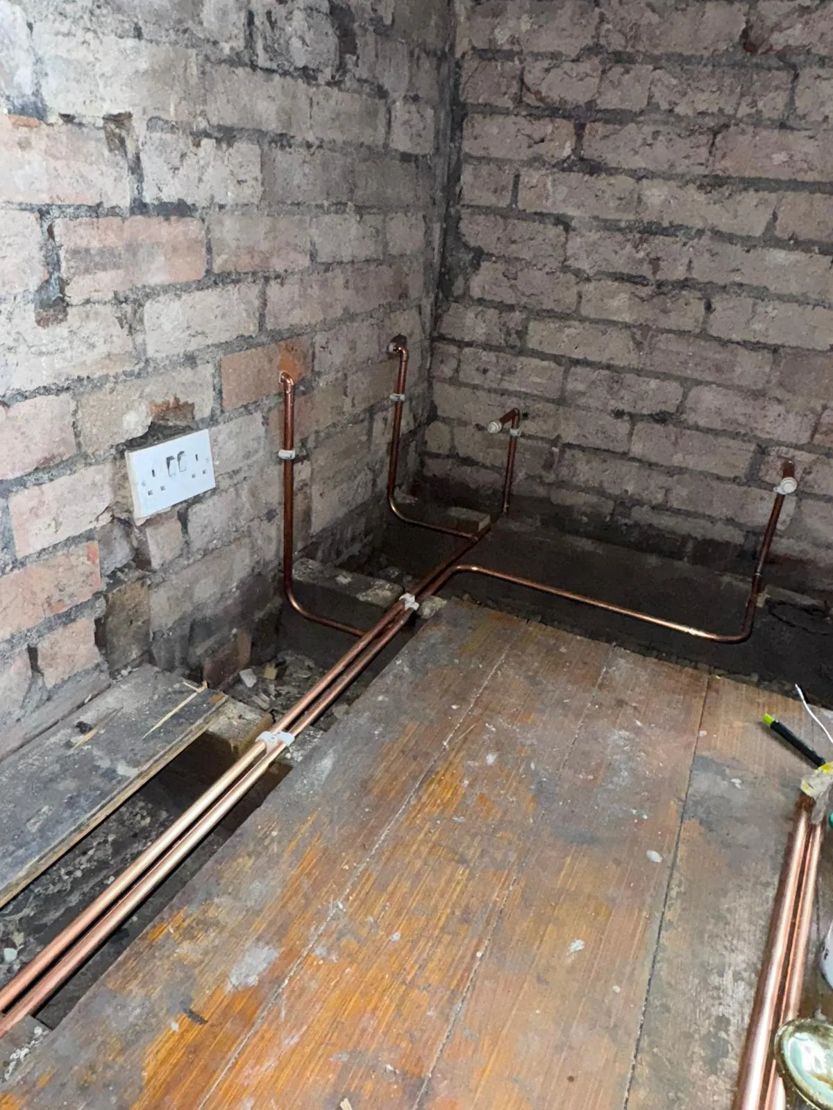 Professional copper plumbing pipe installation during a bathroom or kitchen renovation.