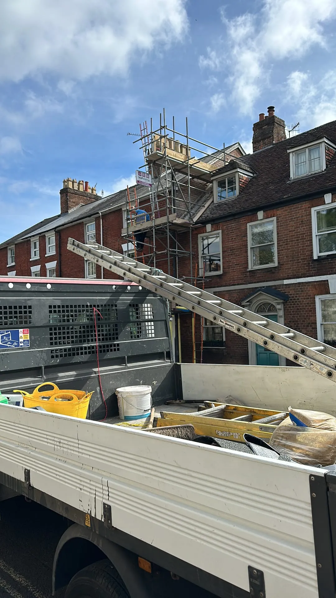 Professional roofers performing chimney repairs and leadwork using scaffolding on a residential home in Portsmouth.