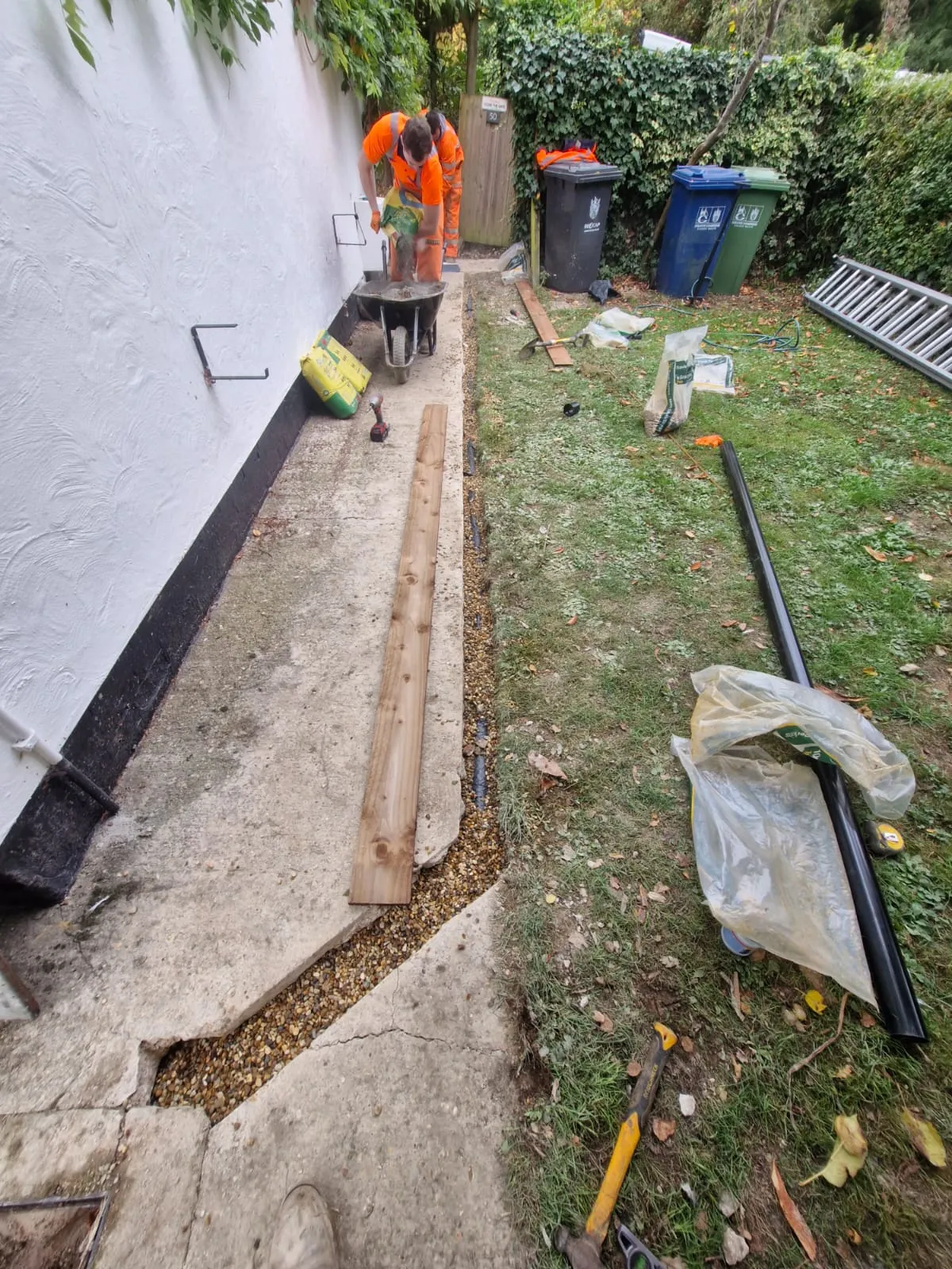 Drainage groundworks and pipe installation by Roberts Drainage Ltd in a residential garden.