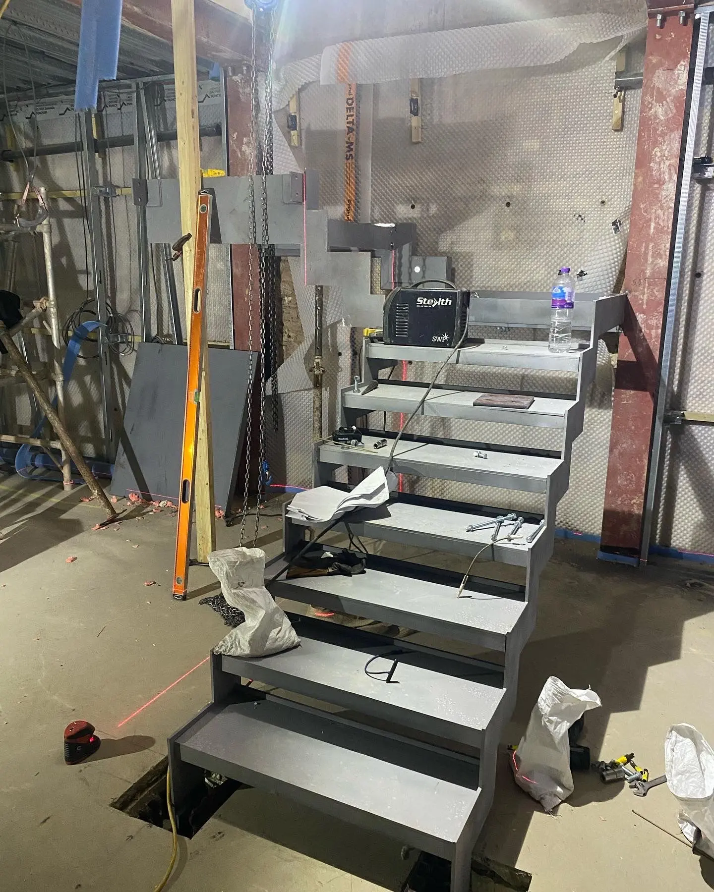 Steel staircase installation and structural steel erection in progress at an ER3 Group LTD construction site