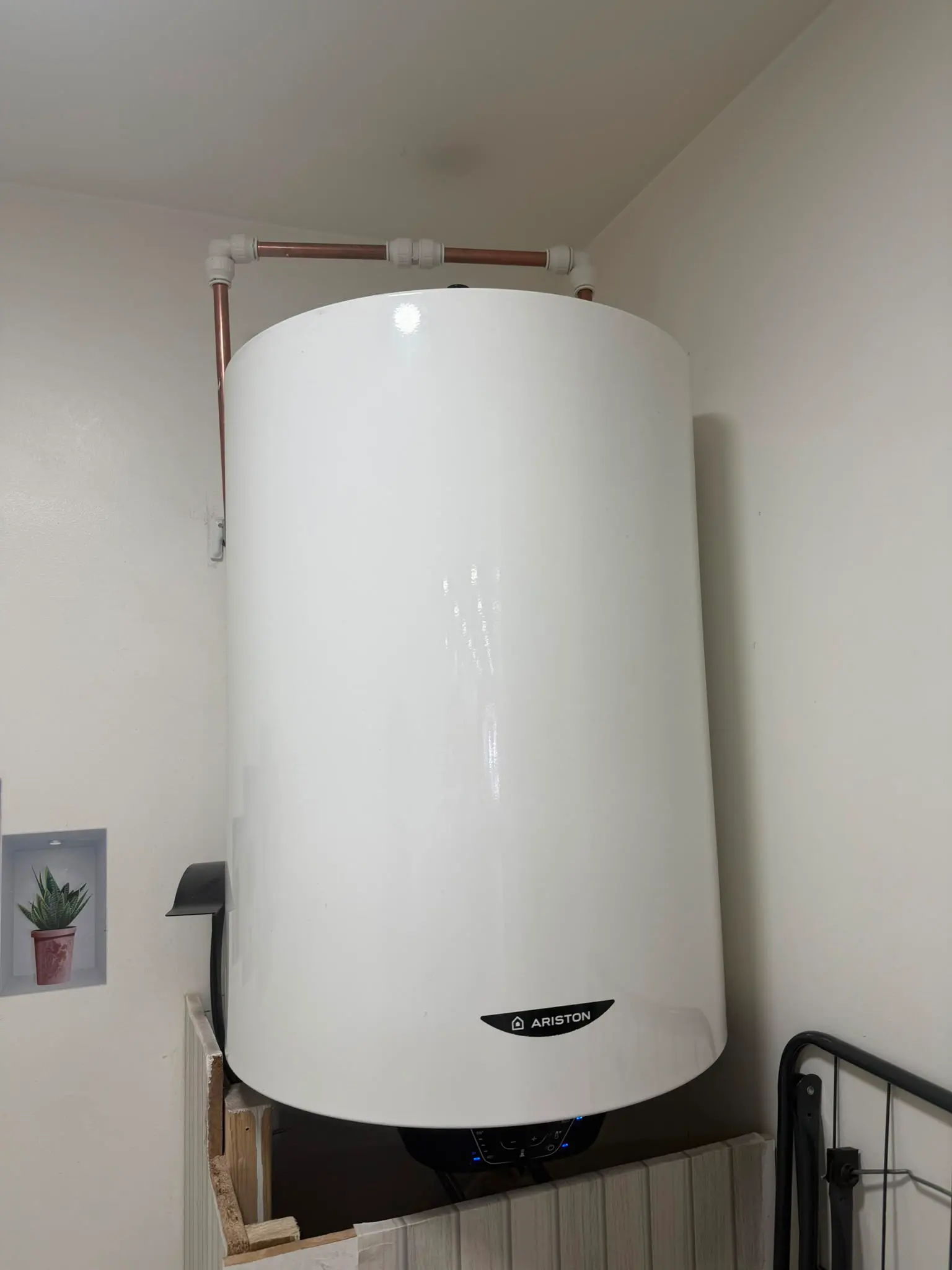 A newly installed Ariston hot water tank and pipework