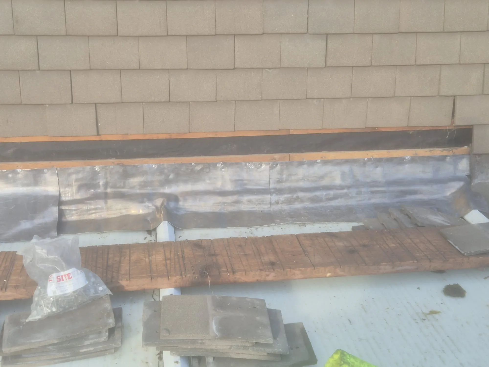 Expert lead flashing and grey roof tile installation on a pitched roof project by Watertight Roofing.