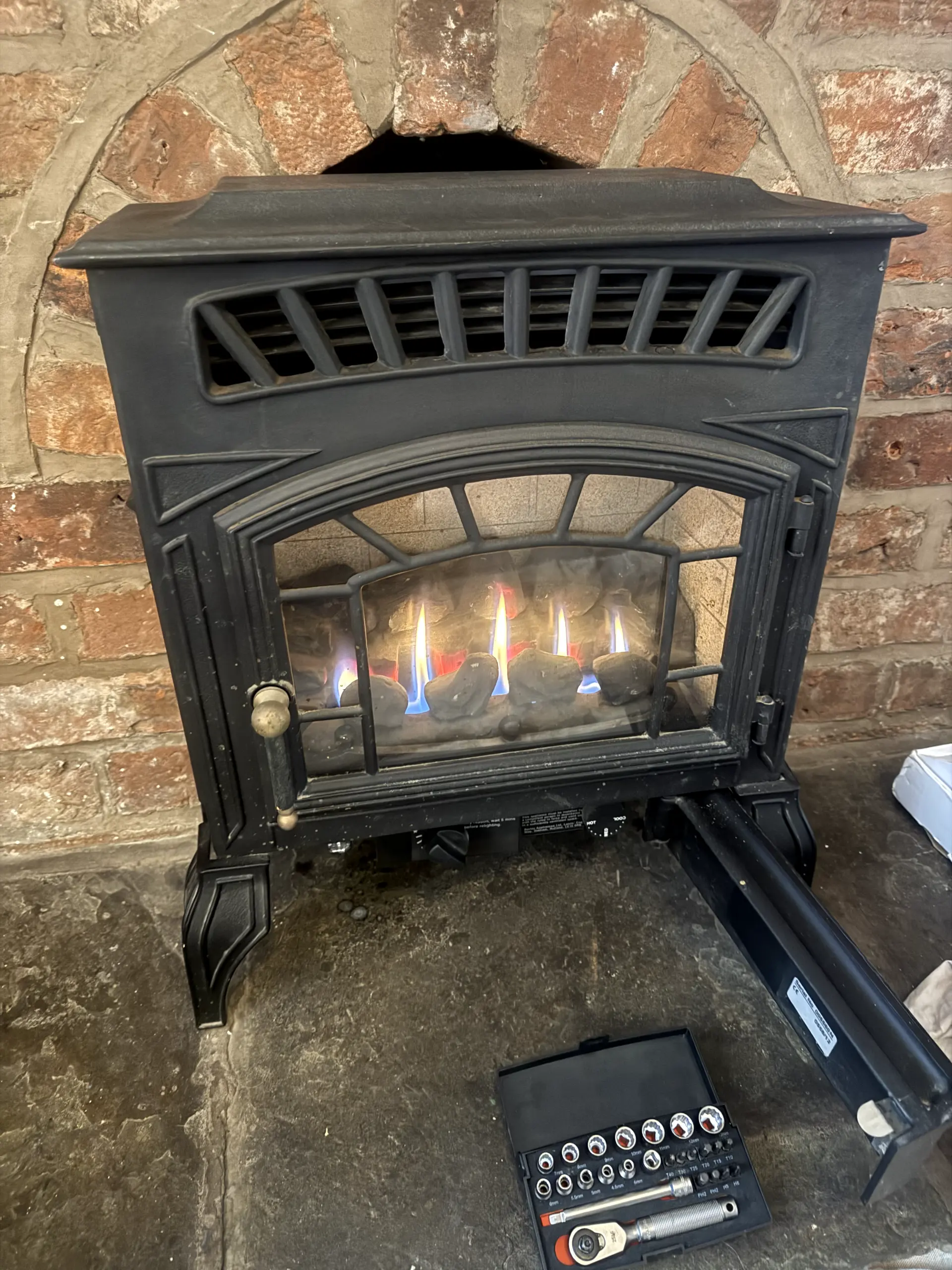 Gas stove servicing and safety check being performed by a Gas Safe engineer from WGS Services.