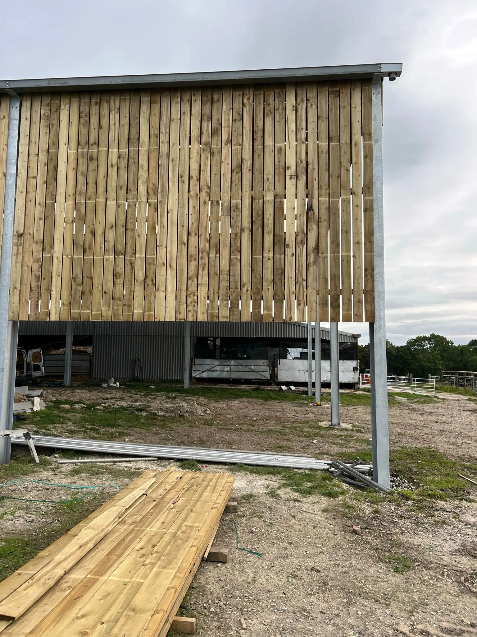 Timber space boarding being installed on a galvanised steel frame agricultural building by ER3 Group LTD