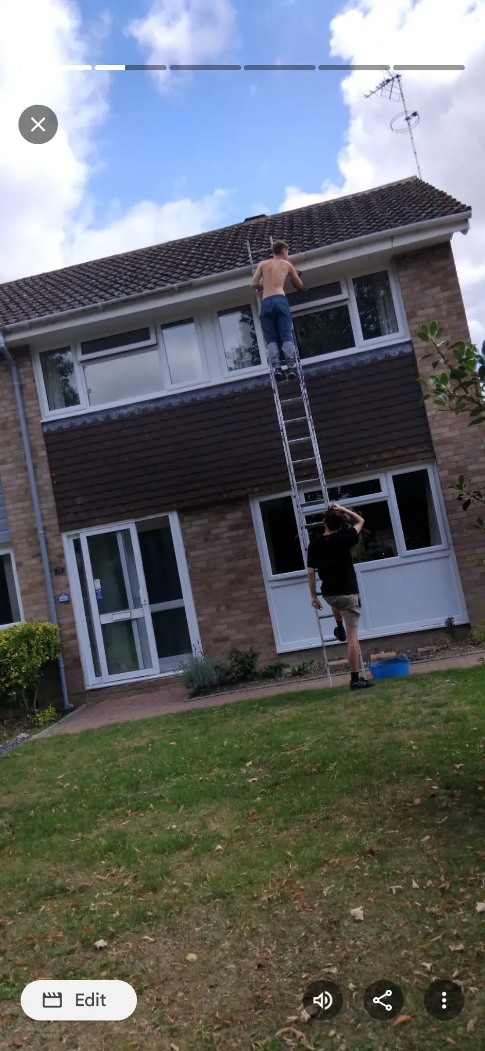 Roofing contractors carrying out guttering repairs and roofline inspection on a two-storey house in Slough