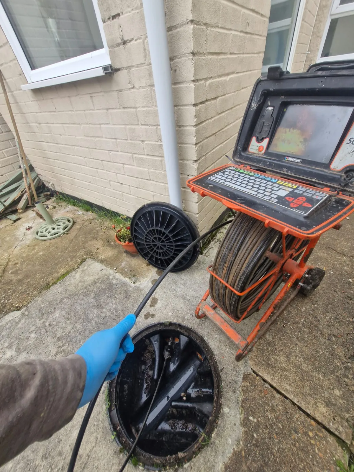 CCTV drain survey equipment being used to inspect an underground pipe.