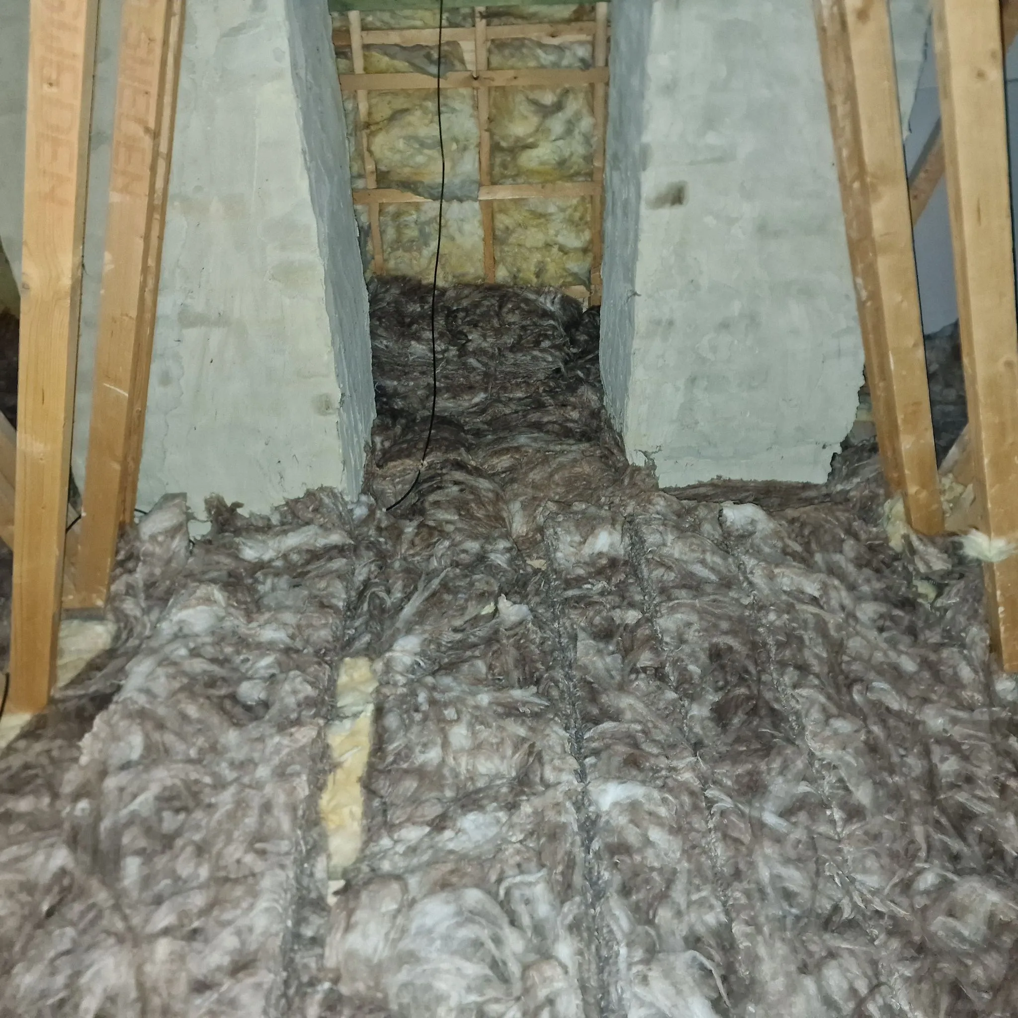 Image of loft insulation, potentially contaminated, indicating the need for loft clearance and sanitisation services.