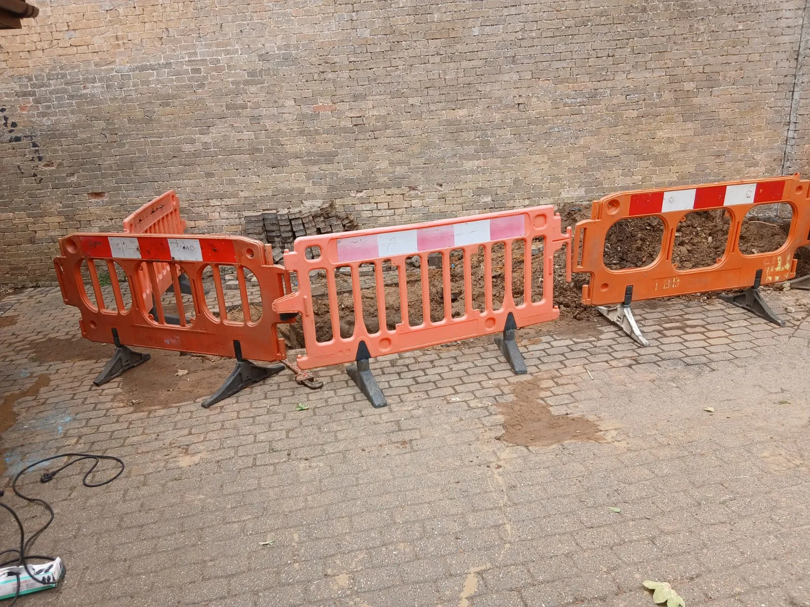 Drainage excavation and groundworks site with safety barriers in Cambridgeshire